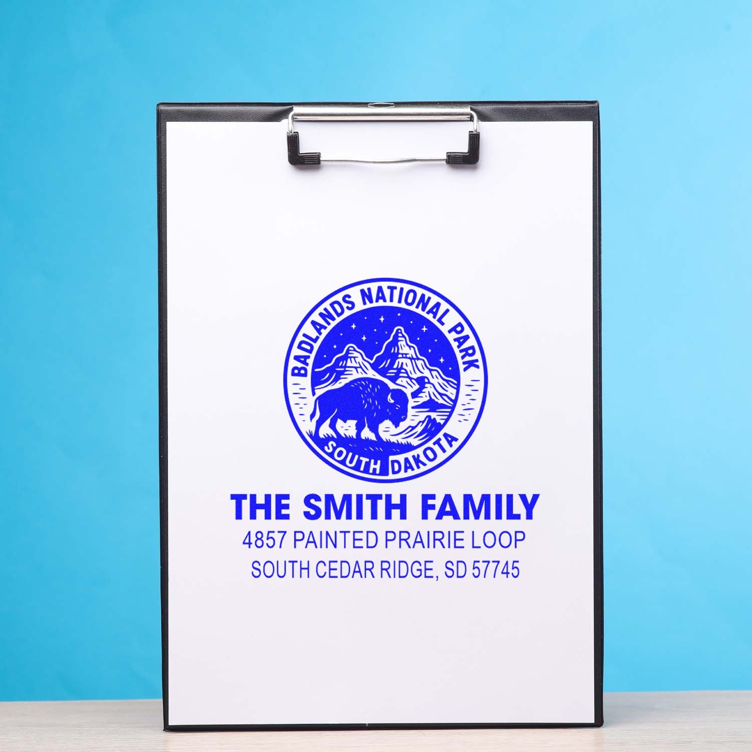Custom rubber stamp proof with Badlands National Park logo and The Smith Family return address on clipboard.