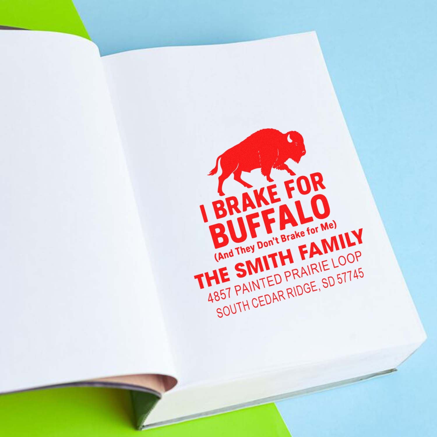 Custom rubber address stamp with buffalo design for the Smith family, shown stamped on paper.