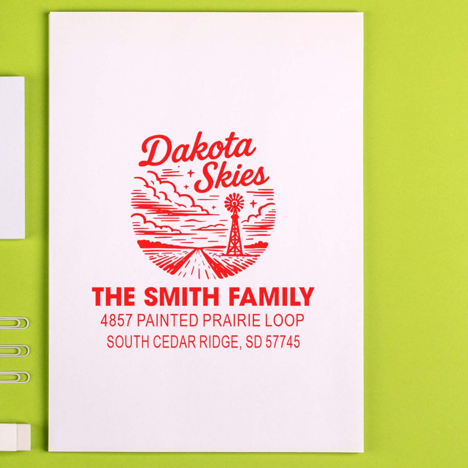 Custom rubber address stamp for Dakota Skies, featuring a prairie windmill design and personalized family name and address.