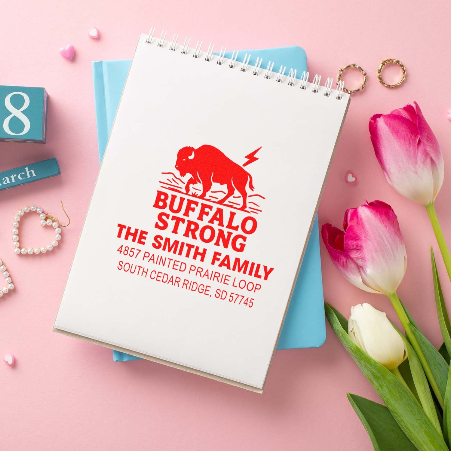 Custom buffalo strong family address rubber stamp with red imprint on notebook, personalized return address for The Smith Family.