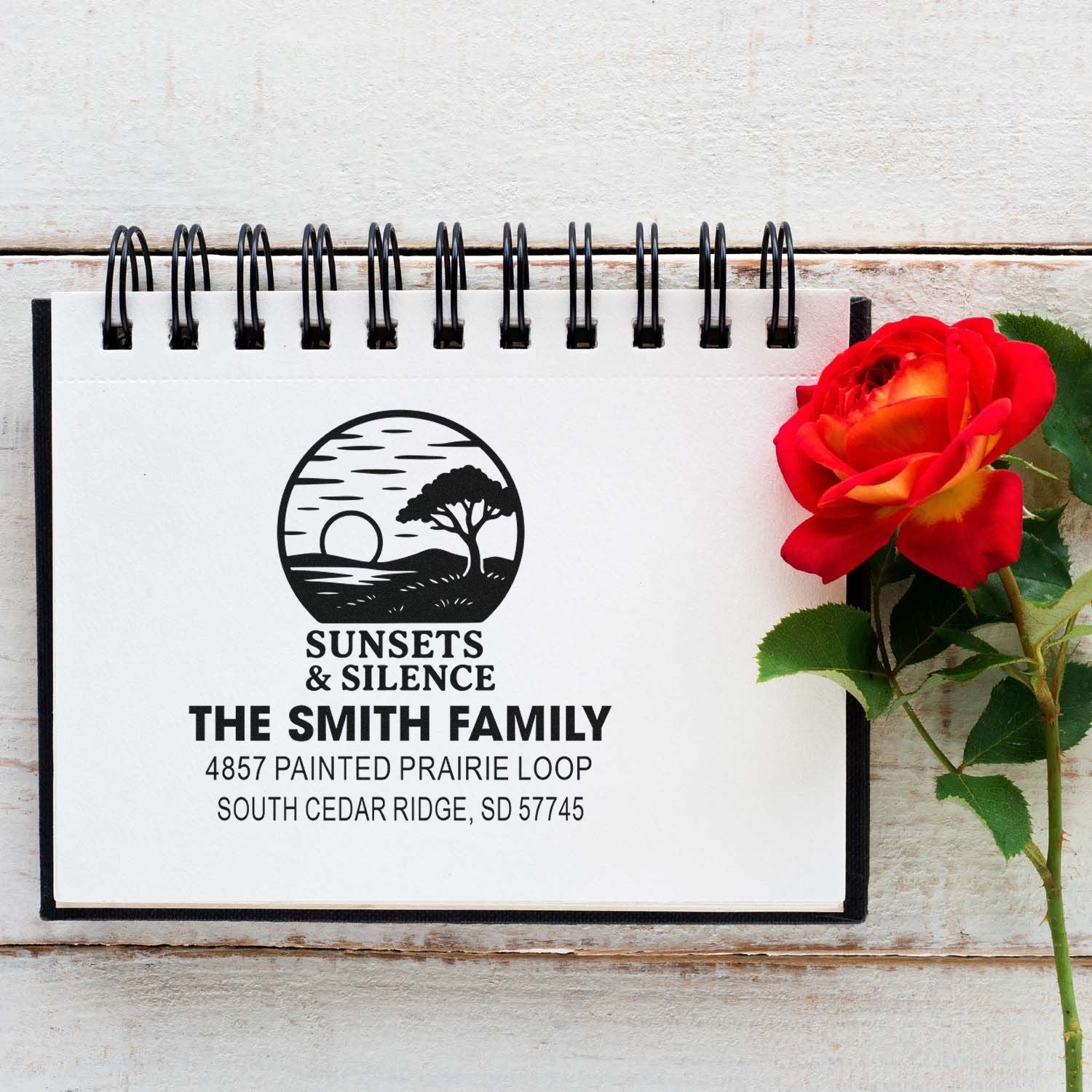 Custom rubber return address stamp for The Smith Family with sunset logo and full mailing address.