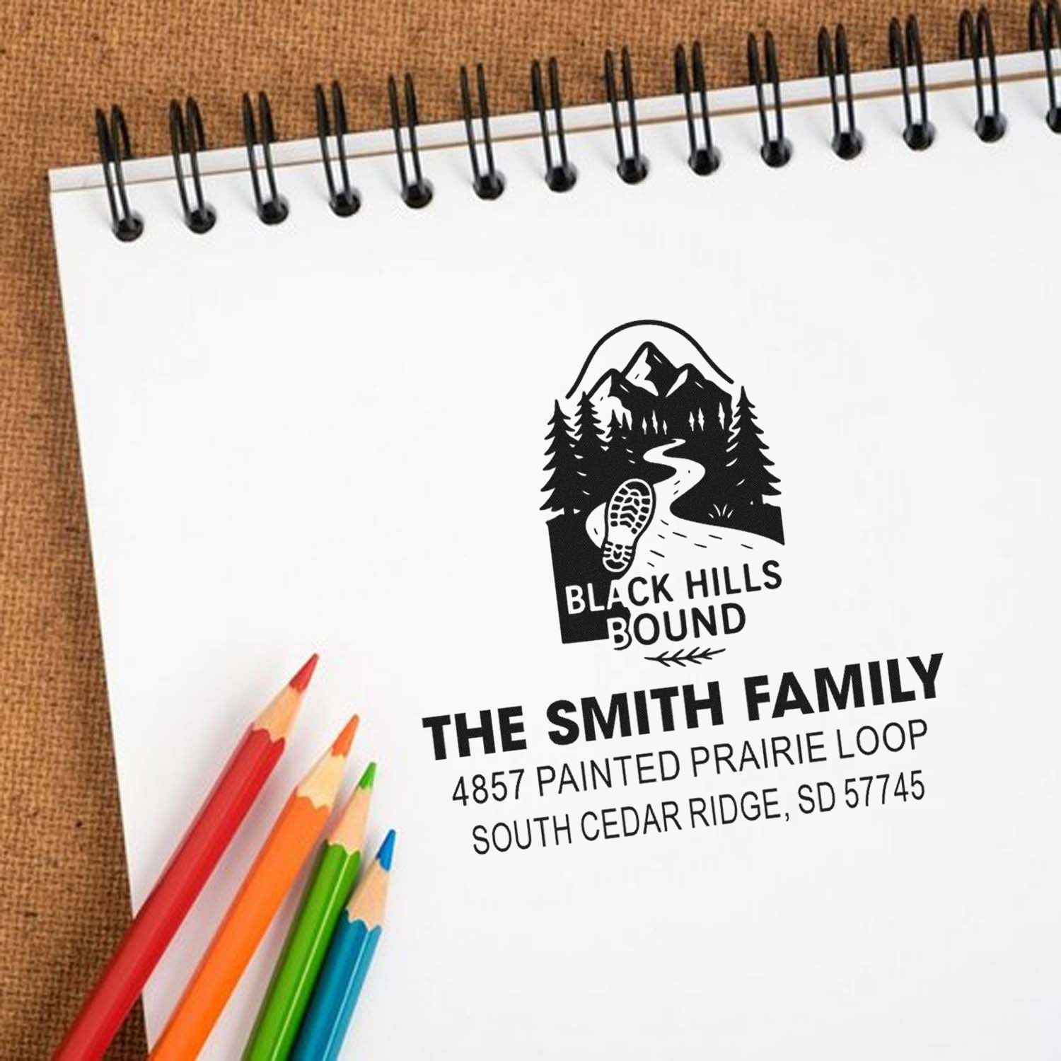 Personalized family return address rubber stamp with Black Hills Bound design on notebook paper