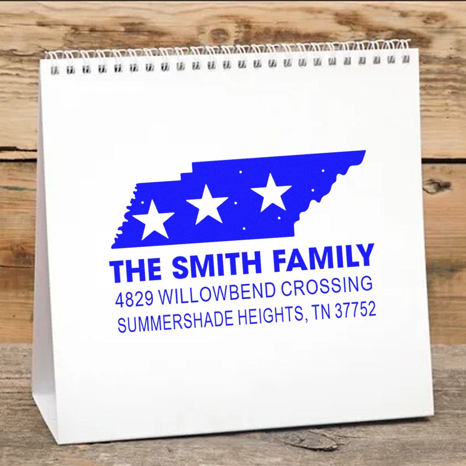 Personalized return address rubber stamp with Tennessee state design and family address on a white gift bag.