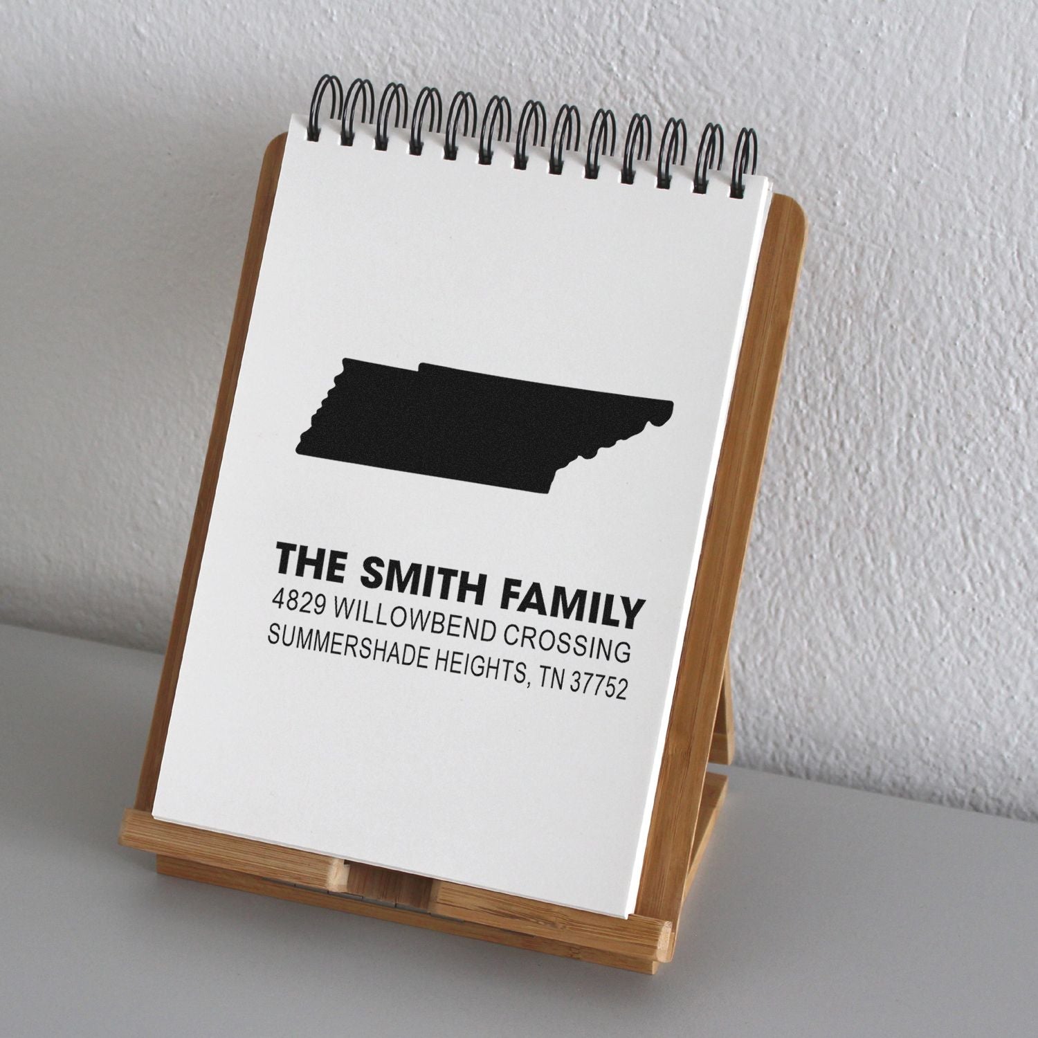 Personalized return address rubber stamp with family name and Tennessee state silhouette for envelopes, cards, and invitations.