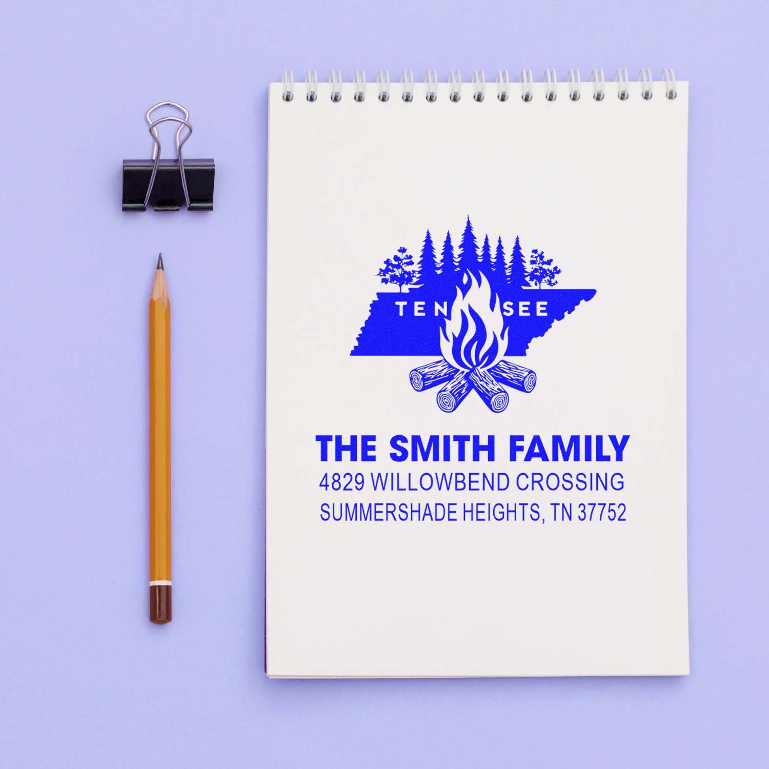 Personalized return address rubber stamp for The Smith Family, featuring a Tennessee campfire logo on notebook mockup.