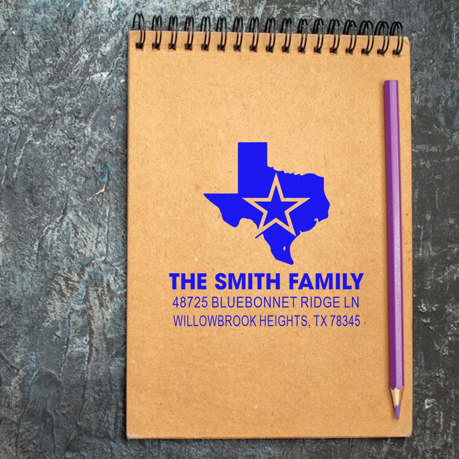 Custom Texas family address rubber stamp design on a notebook, featuring a state outline and personalized return address.