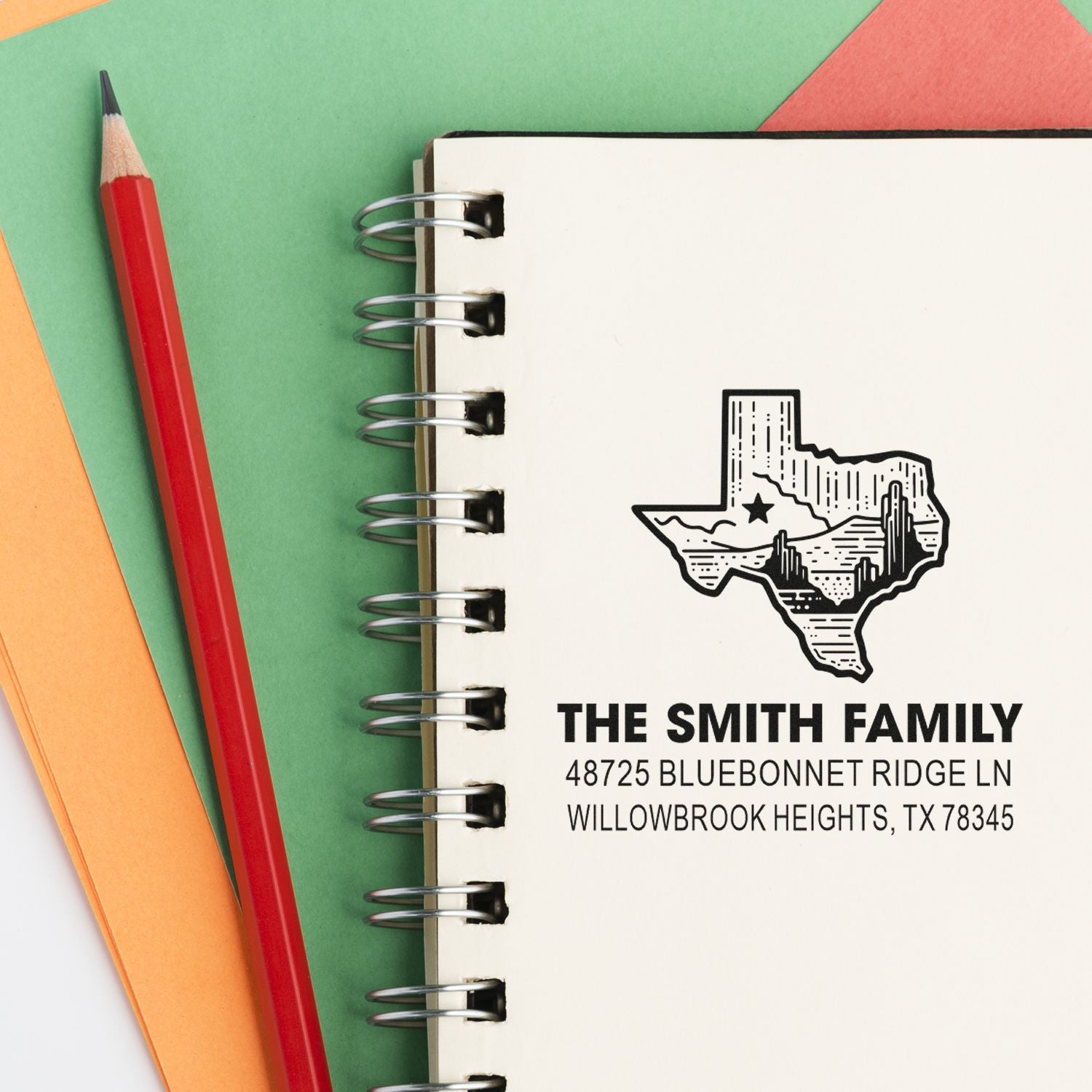 Personalized return address rubber stamp on notebook, featuring The Smith Family and Texas address for custom stationery.