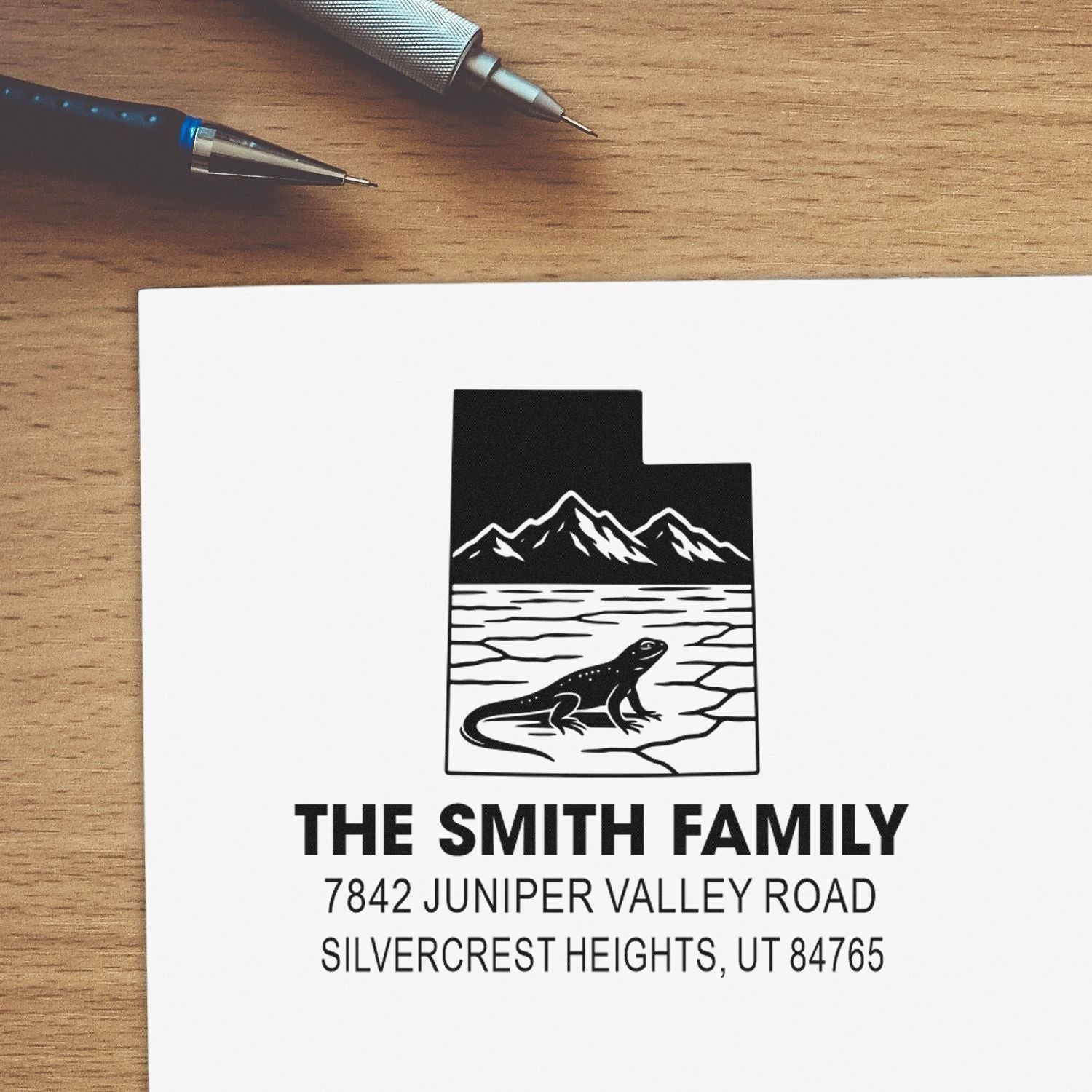Personalized family return address rubber stamp with mountain lizard logo and custom address.