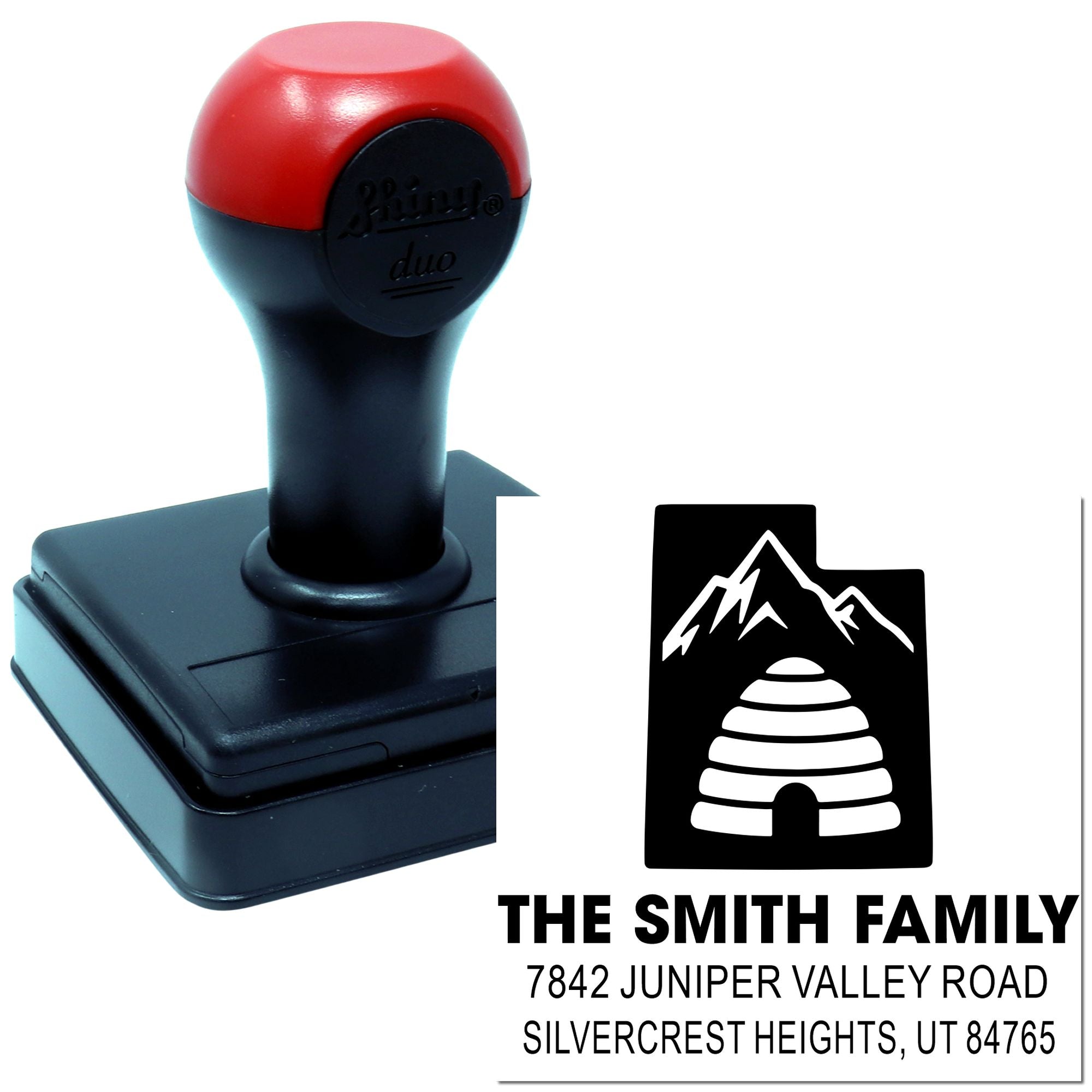 Custom self-inking rubber return address stamp with family name, address and mountain logo for personalized mailing.
