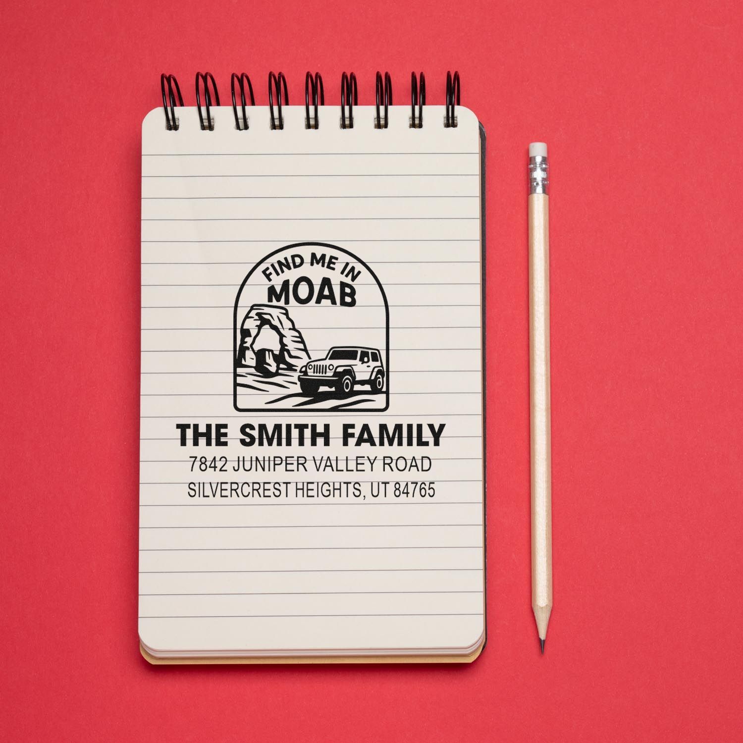 Custom rubber address stamp on notebook, featuring a Find Me in Moab jeep design for The Smith Family return address.