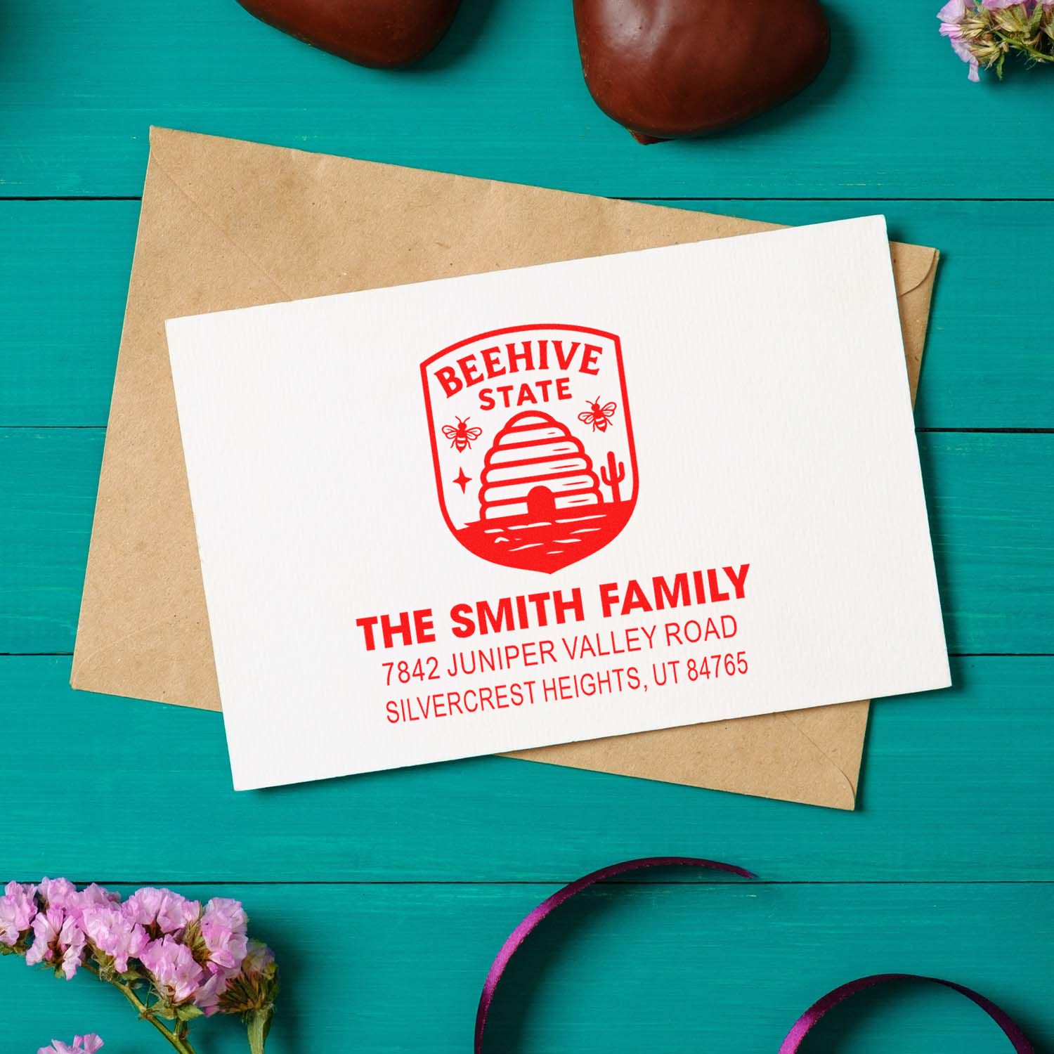 Custom return address rubber stamp with beehive state logo for The Smith Family on a card and envelope.