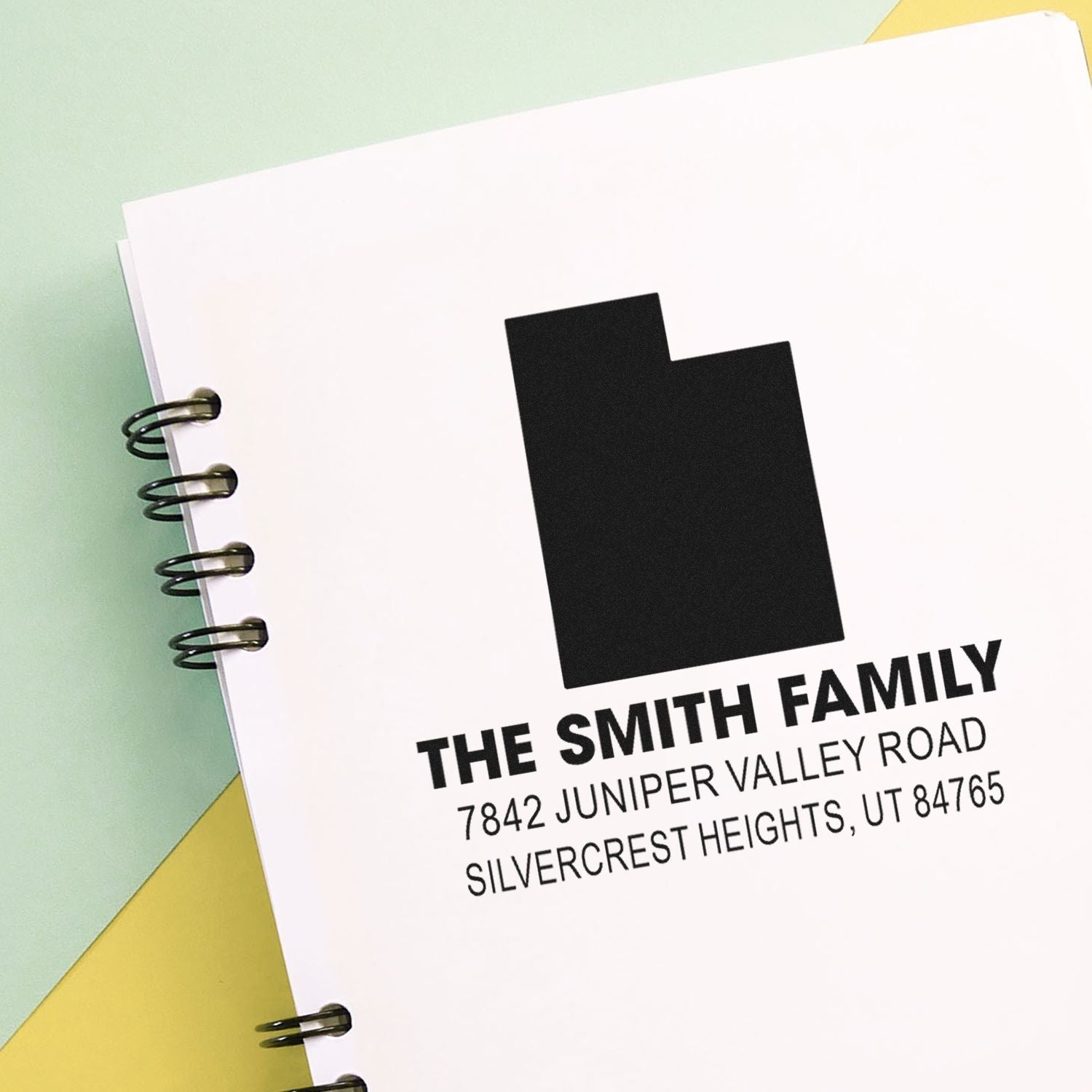 Custom family address rubber stamp with house icon, name, and return address for envelopes and personalized mail.