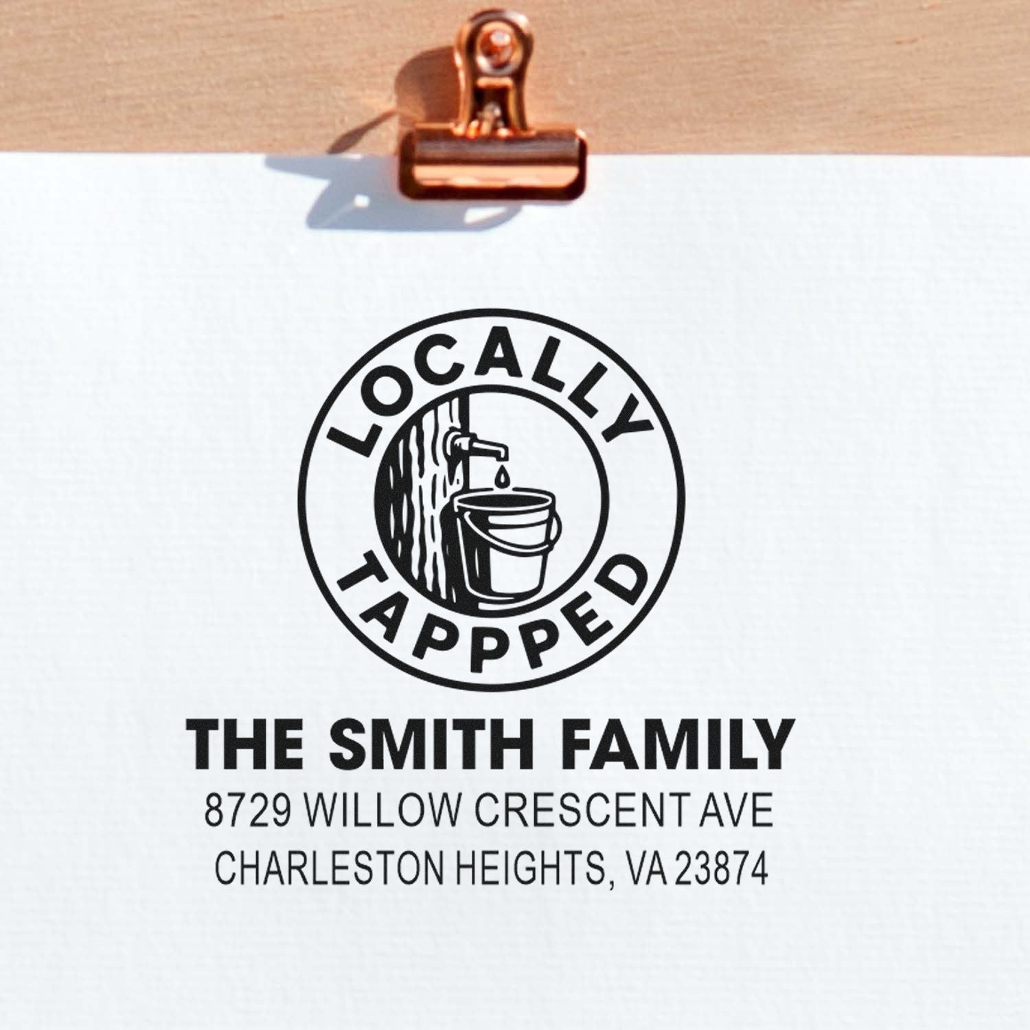 Custom return address stamp on clipped paper, featuring Locally Tapped logo, The Smith Family name, and Charleston Heights, VA address.