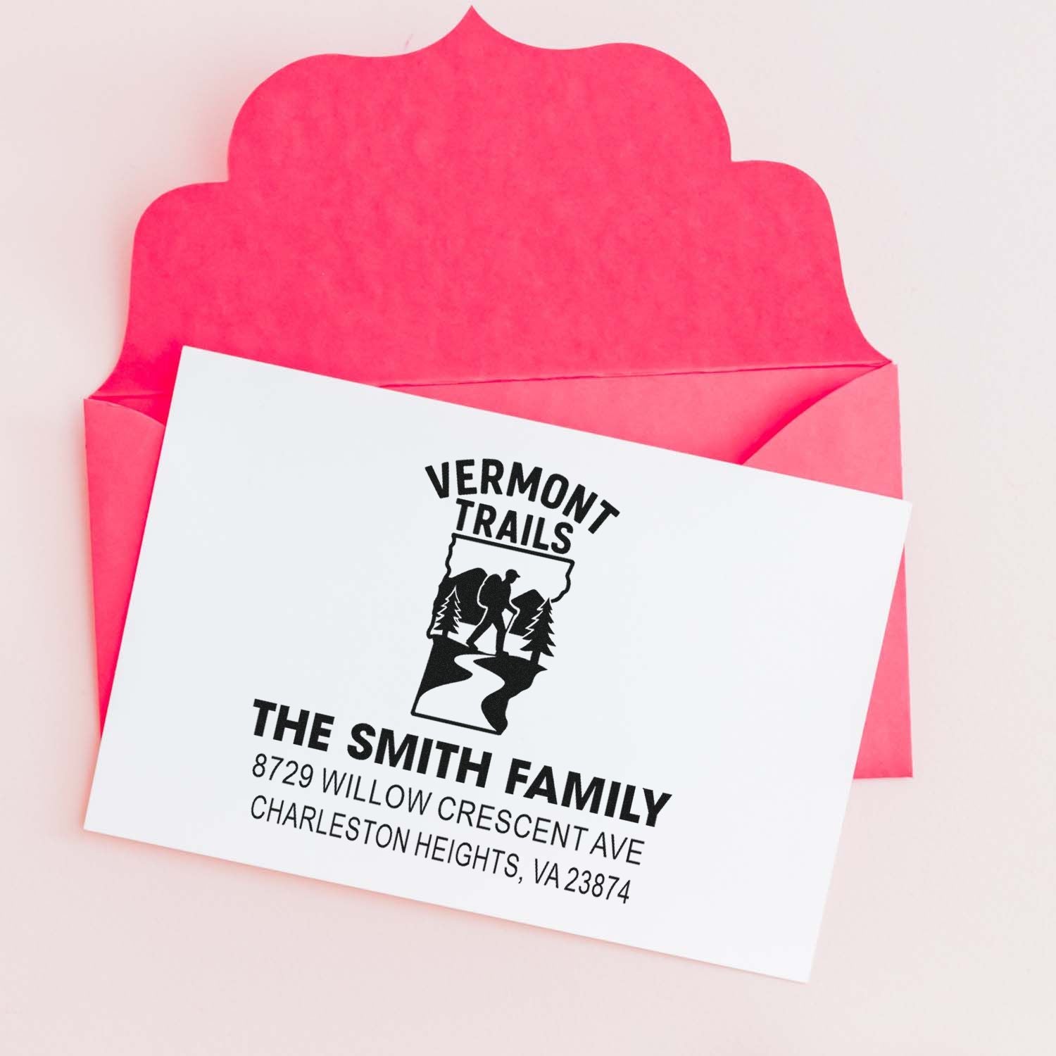 Custom return address rubber stamp with Vermont Trails logo and Smith family address on a pink envelope card