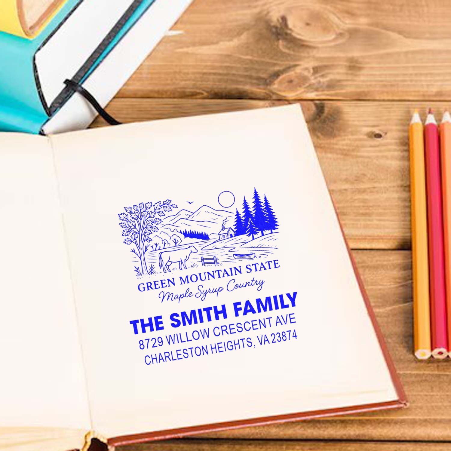 Custom family address rubber stamp with mountain landscape design for personalized stationery and home use.