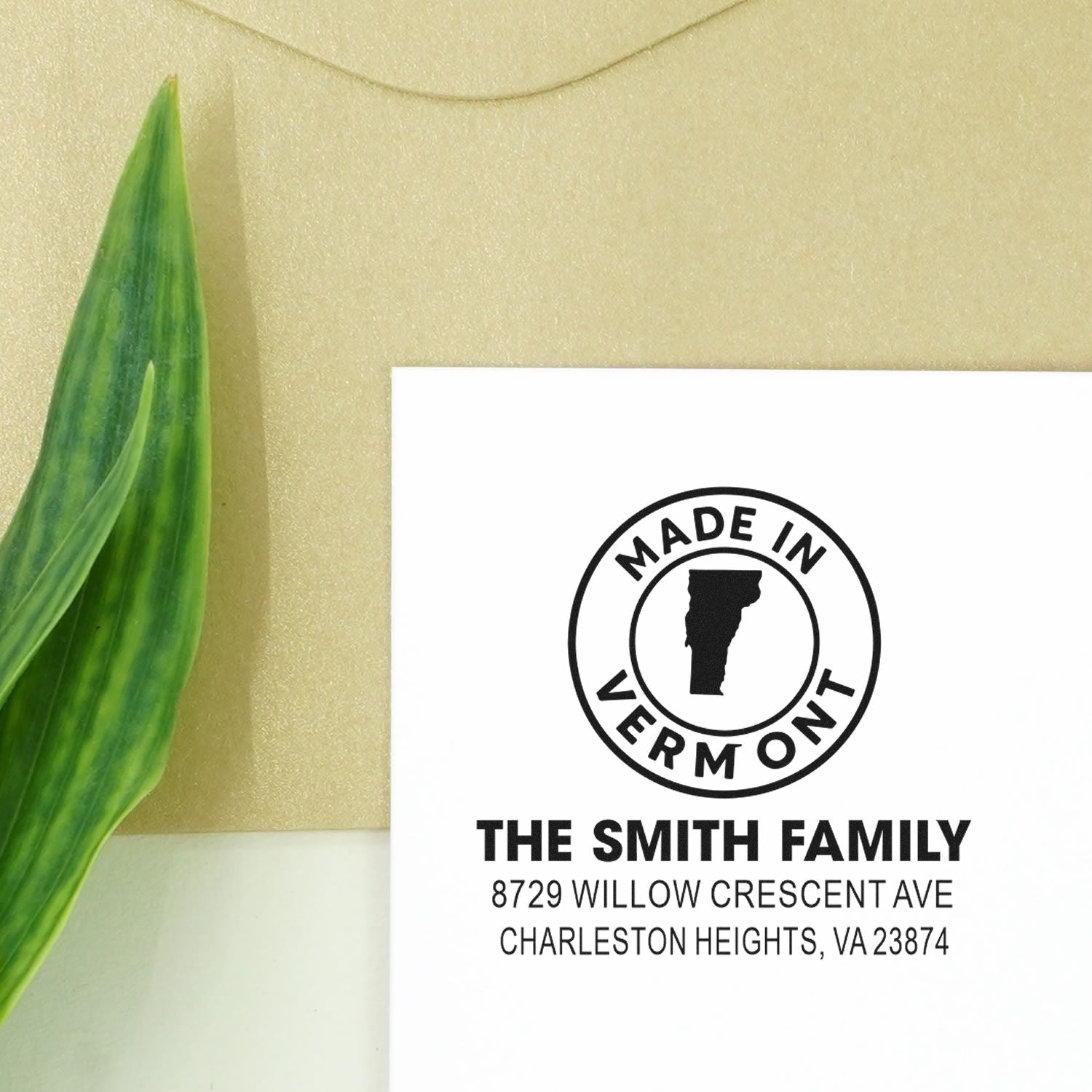 Custom Made in Vermont return address stamp for The Smith Family, featuring name and address on white card beside a green leaf.