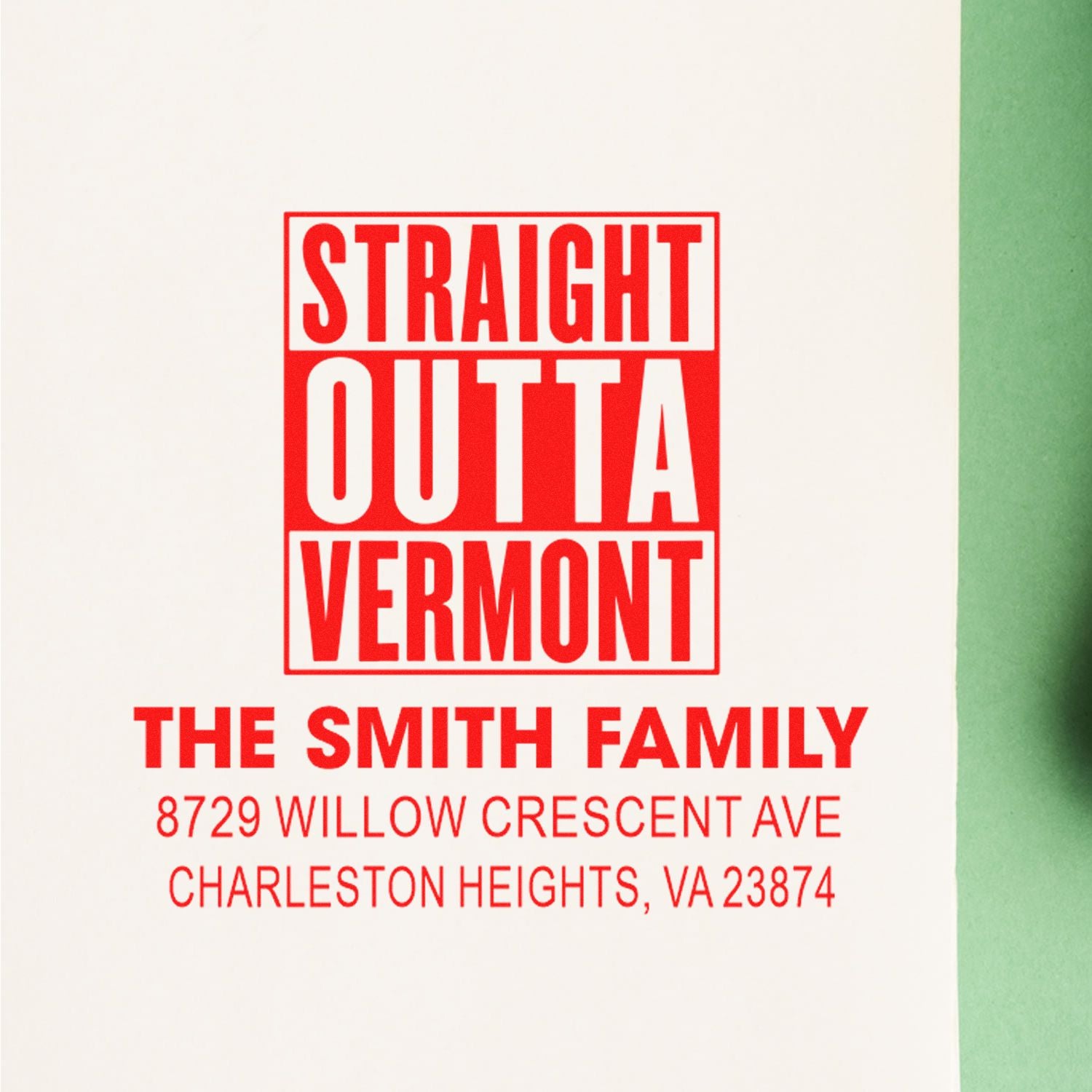 Red custom address stamp reading Straight Outta Vermont for The Smith Family, with Charleston Heights, VA address on white paper.