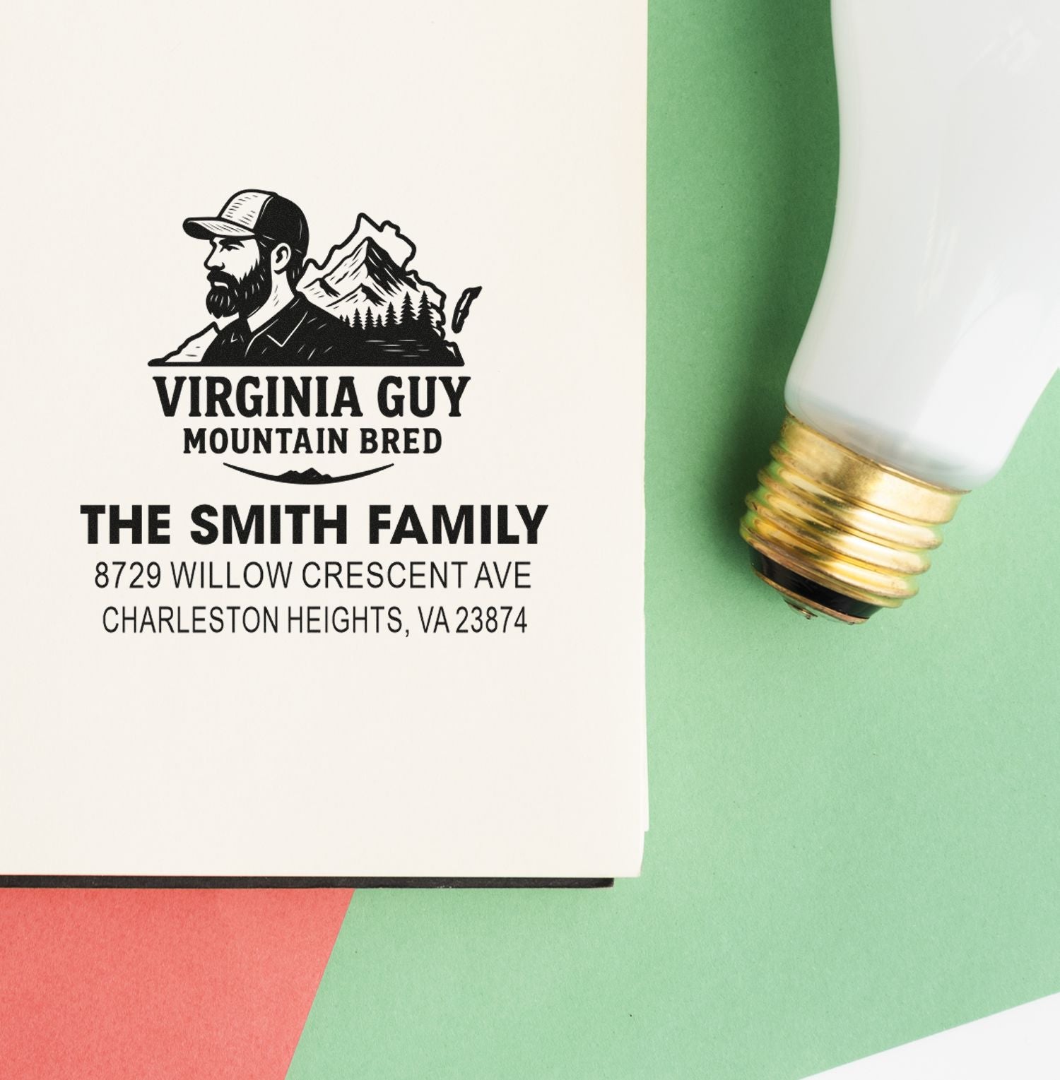 Custom address stamp for The Smith Family with Virginia Guy Mountain Bred logo, shown on paper beside a stamp tool on green background.