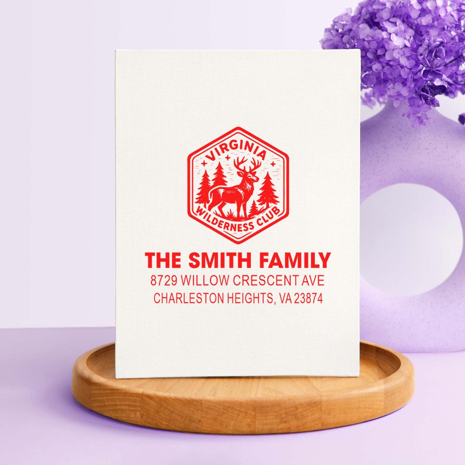 Custom red Virginia Wilderness Club address stamp for The Smith Family on a white card, displayed on a wooden tray with lavender decor.