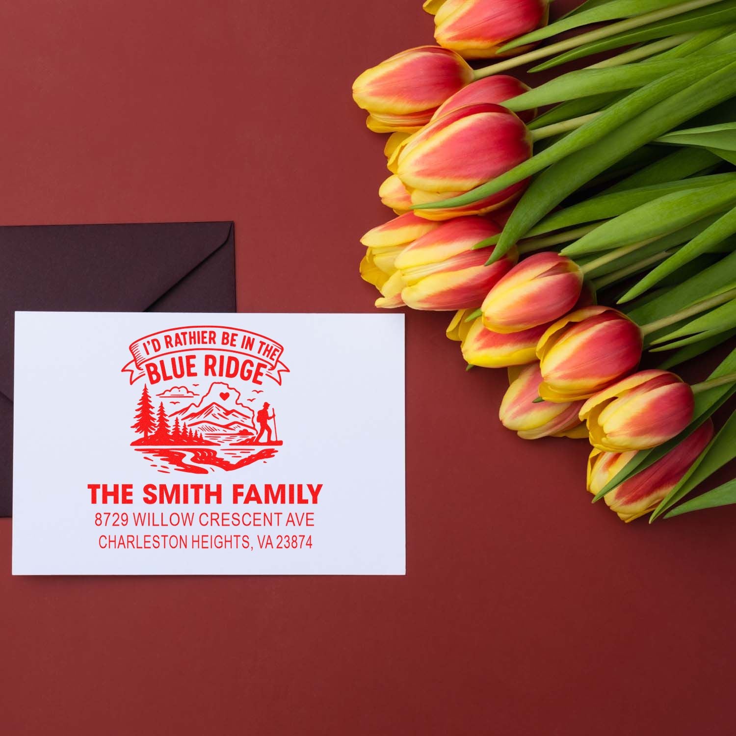 Custom rubber return address stamp for The Smith Family with Blue Ridge mountain design on a mailed envelope.