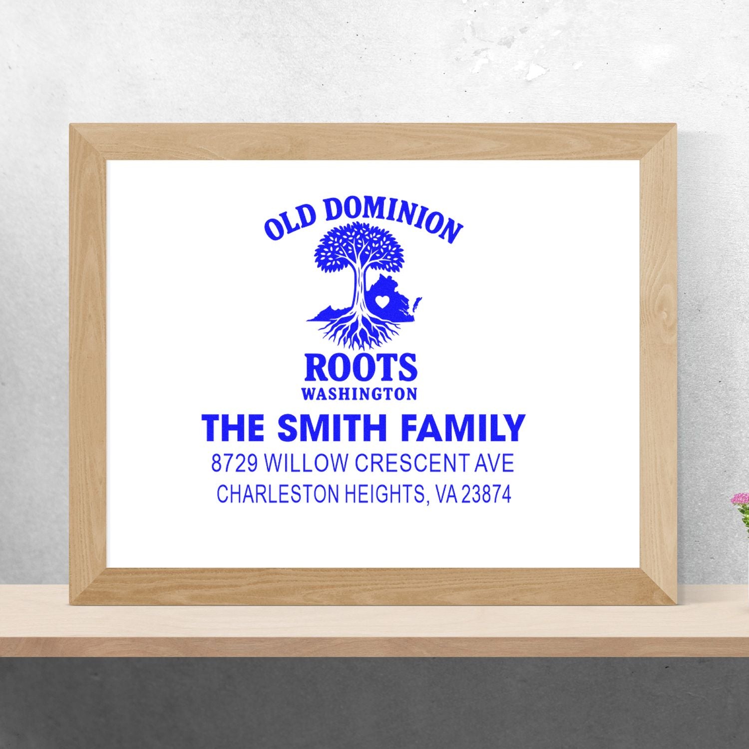 Custom address stamp in blue ink with Old Dominion Roots logo and The Smith Family address, displayed in a wooden frame on a shelf.