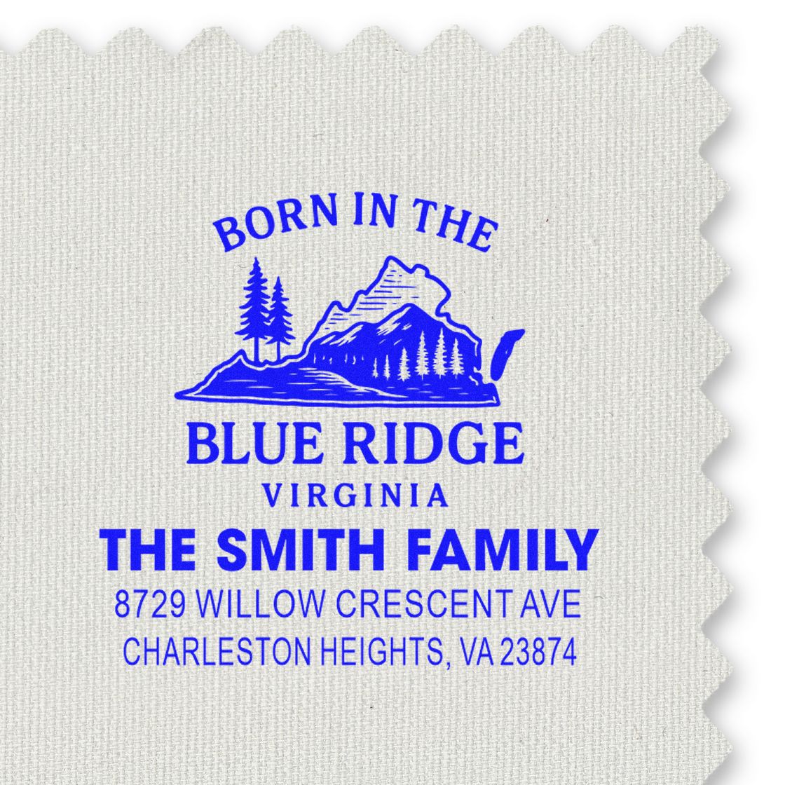 Blue custom address stamp for The Smith Family, Born in the Blue Ridge Virginia, with mountain and pine logo on textured fabric.