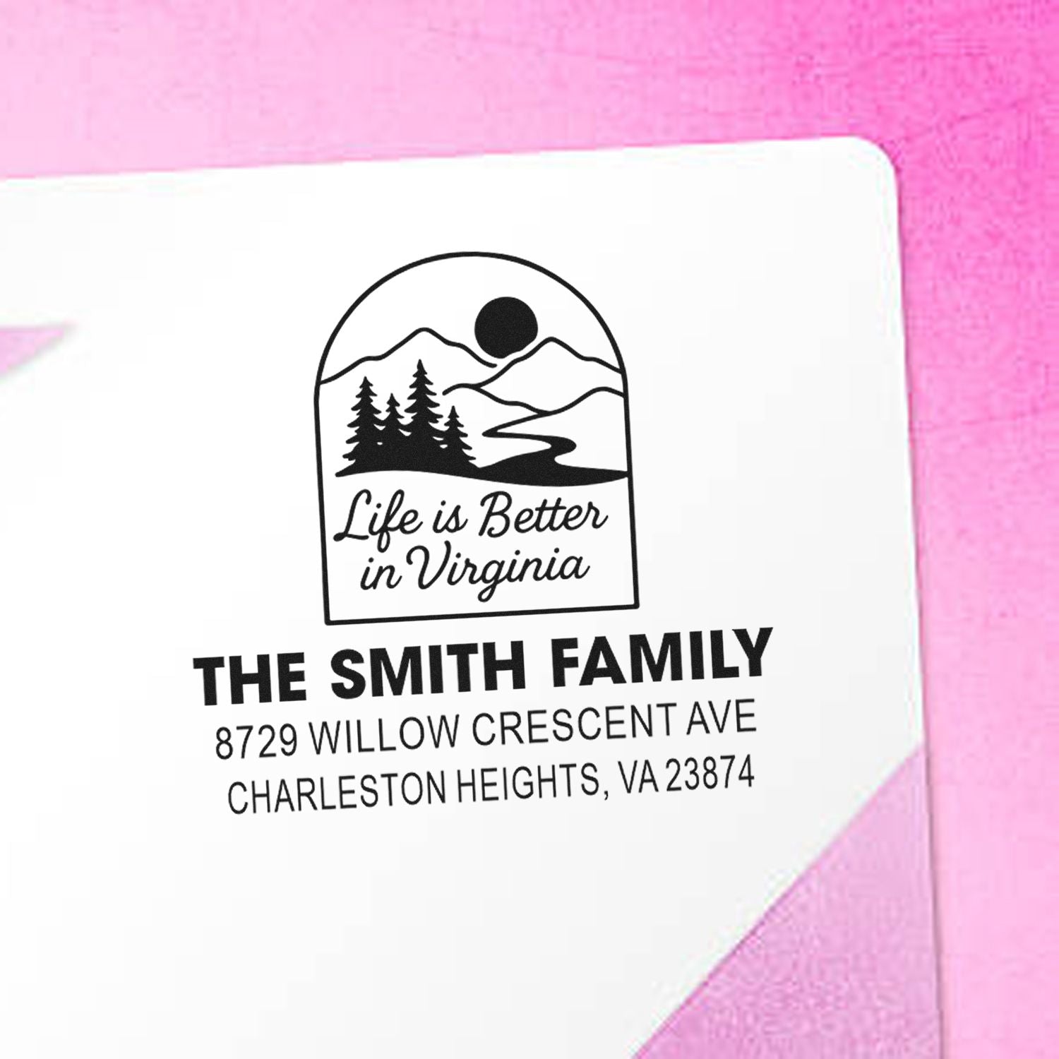 Custom address stamp for The Smith Family with Virginia mountain, trees and river logo, plus personalized address on a white card with pink background.