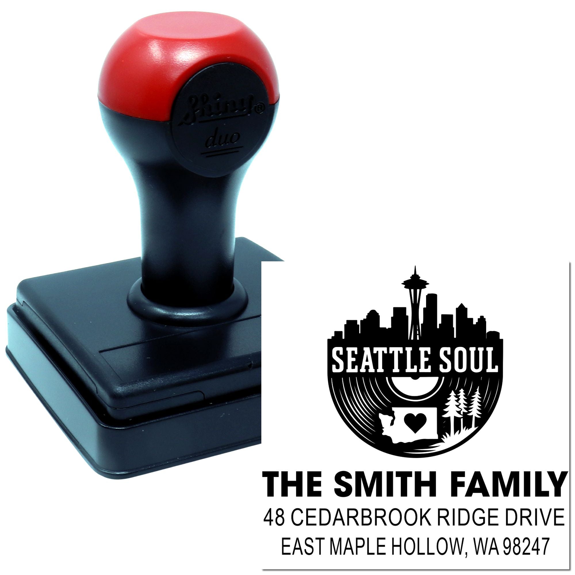Custom self-inking address stamp with Seattle Soul skyline design, shown beside the black and red stamp handle on a white background.