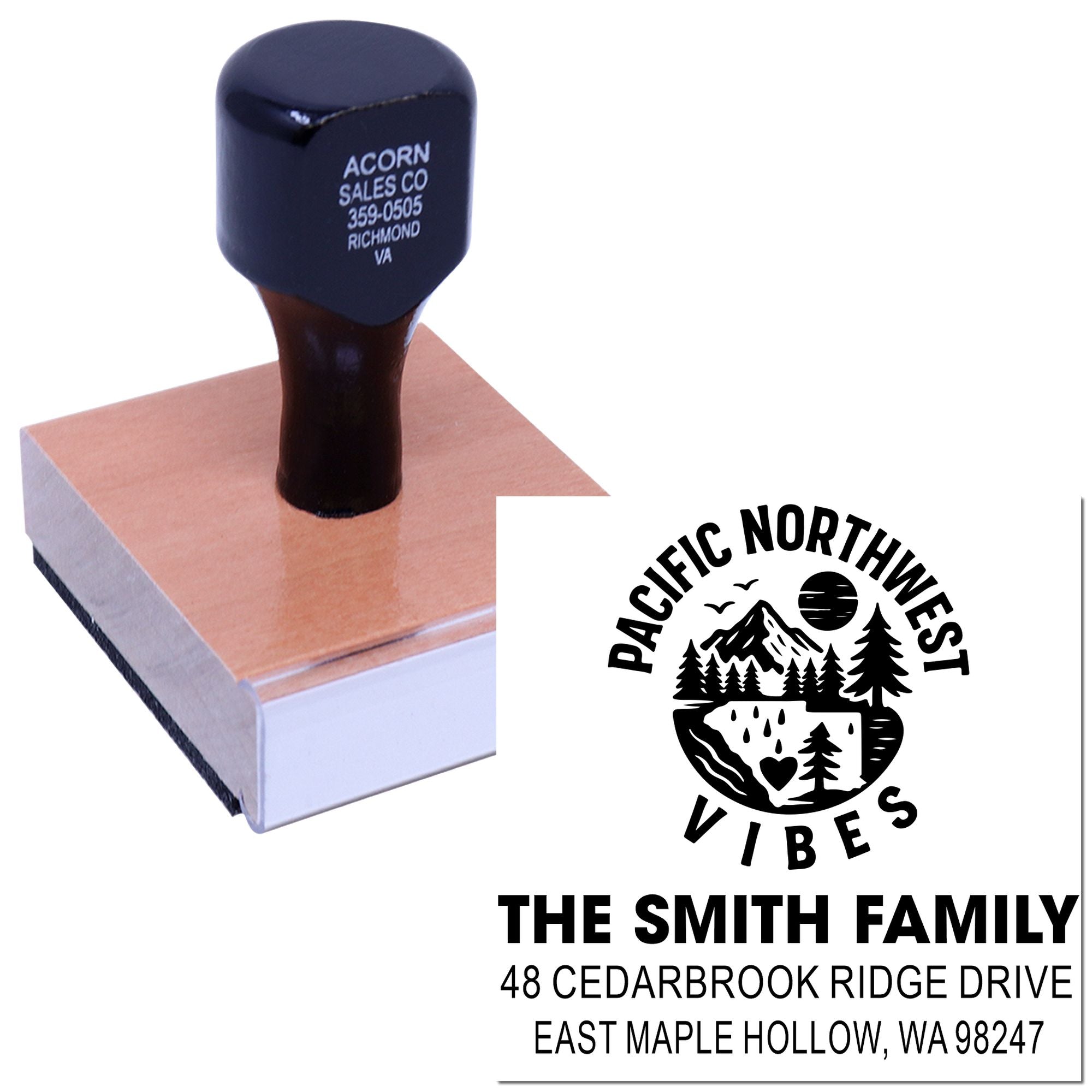 Custom self-inking address stamp on a wooden block, showing a Pacific Northwest Vibes family return address imprint with mountain and forest design.
