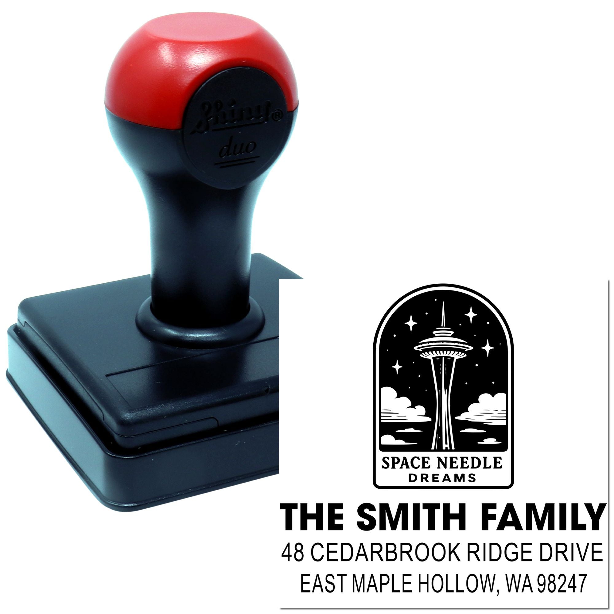 Custom self-inking address stamp with Space Needle design and The Smith Family return address on a white background.