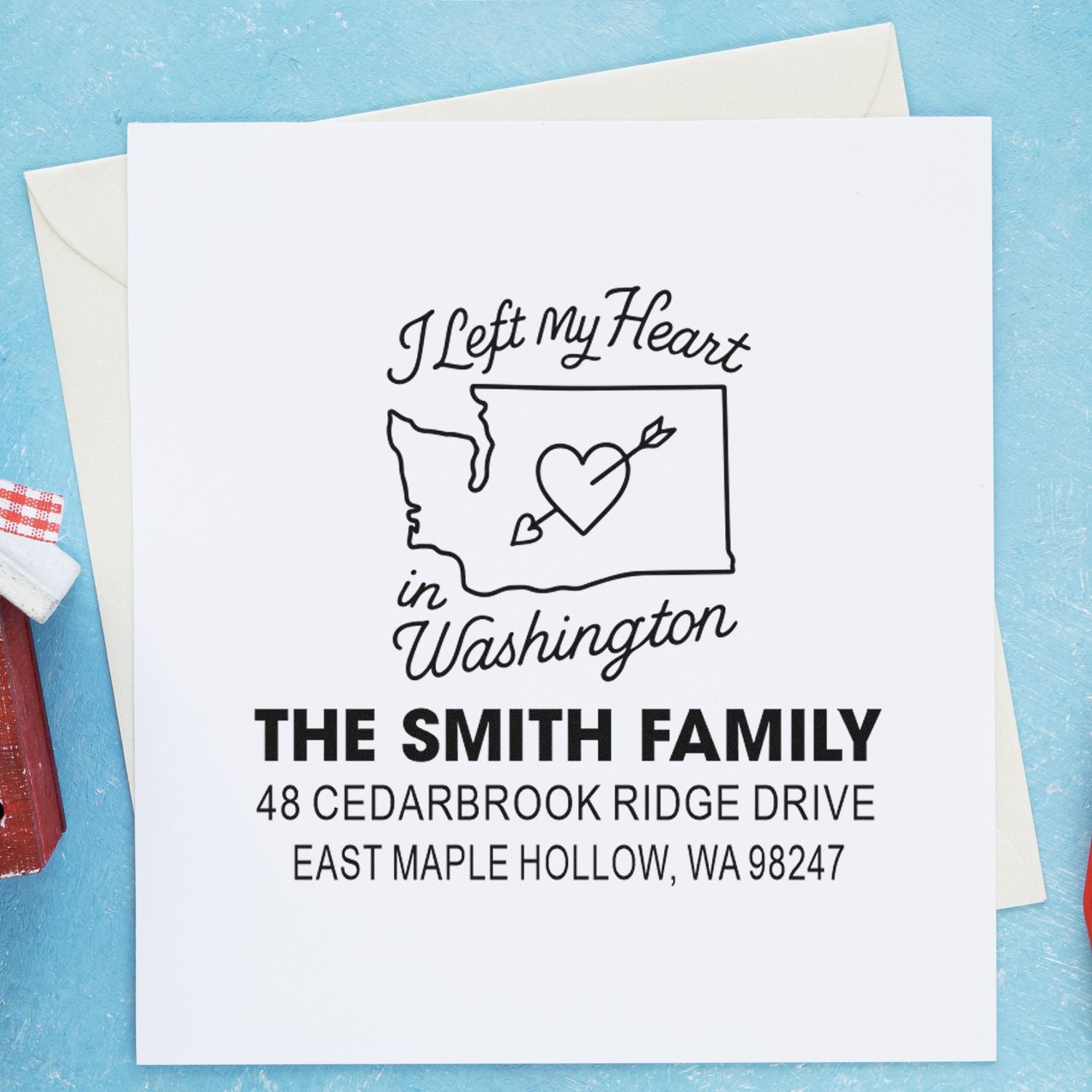 Personalized return address stamp with Washington heart design, shown on a white card beside envelopes, featuring the Smith family name and mailing address.