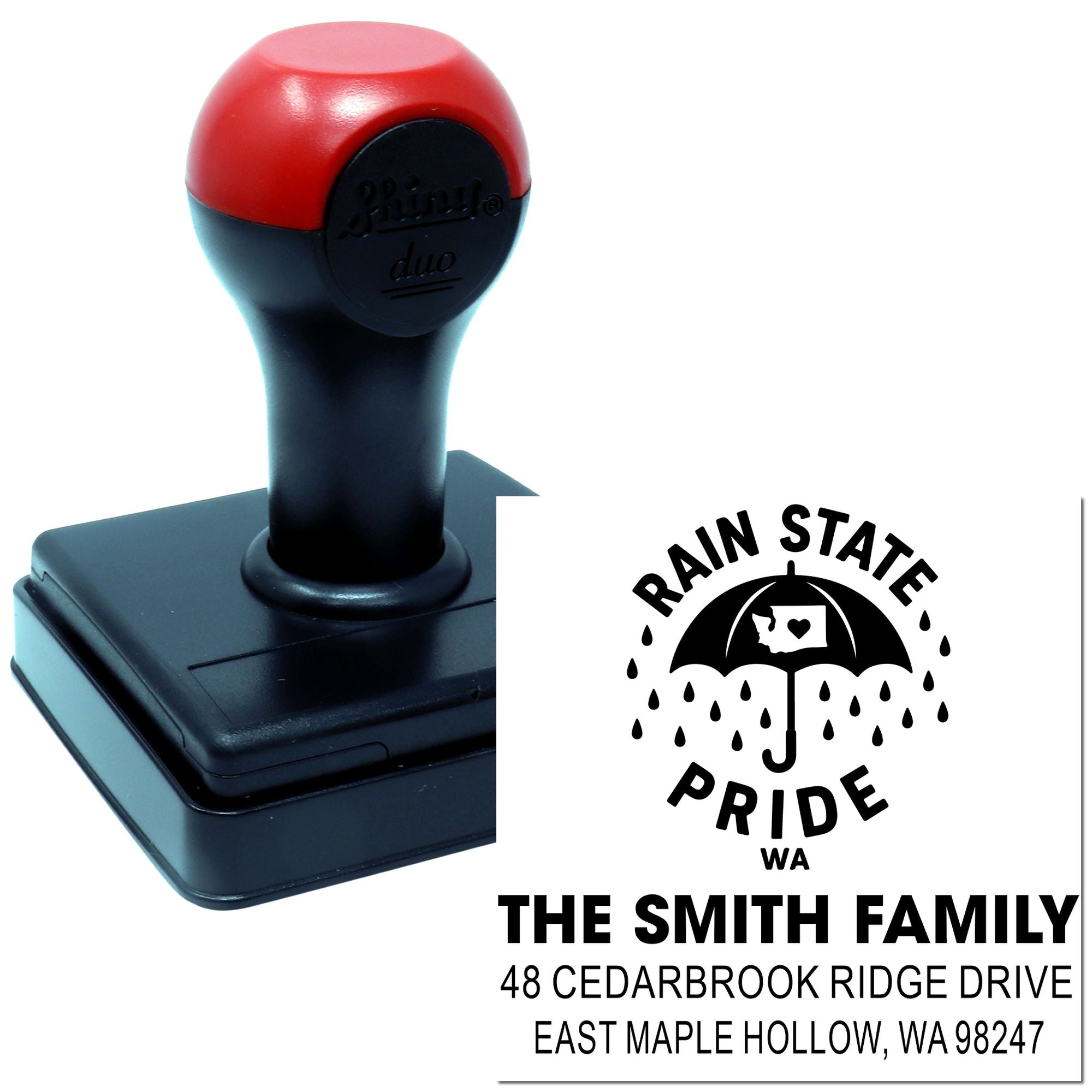 Custom self-inking address stamp with red-and-black handle, showing Rain State Pride umbrella logo and The Smith Family return address.