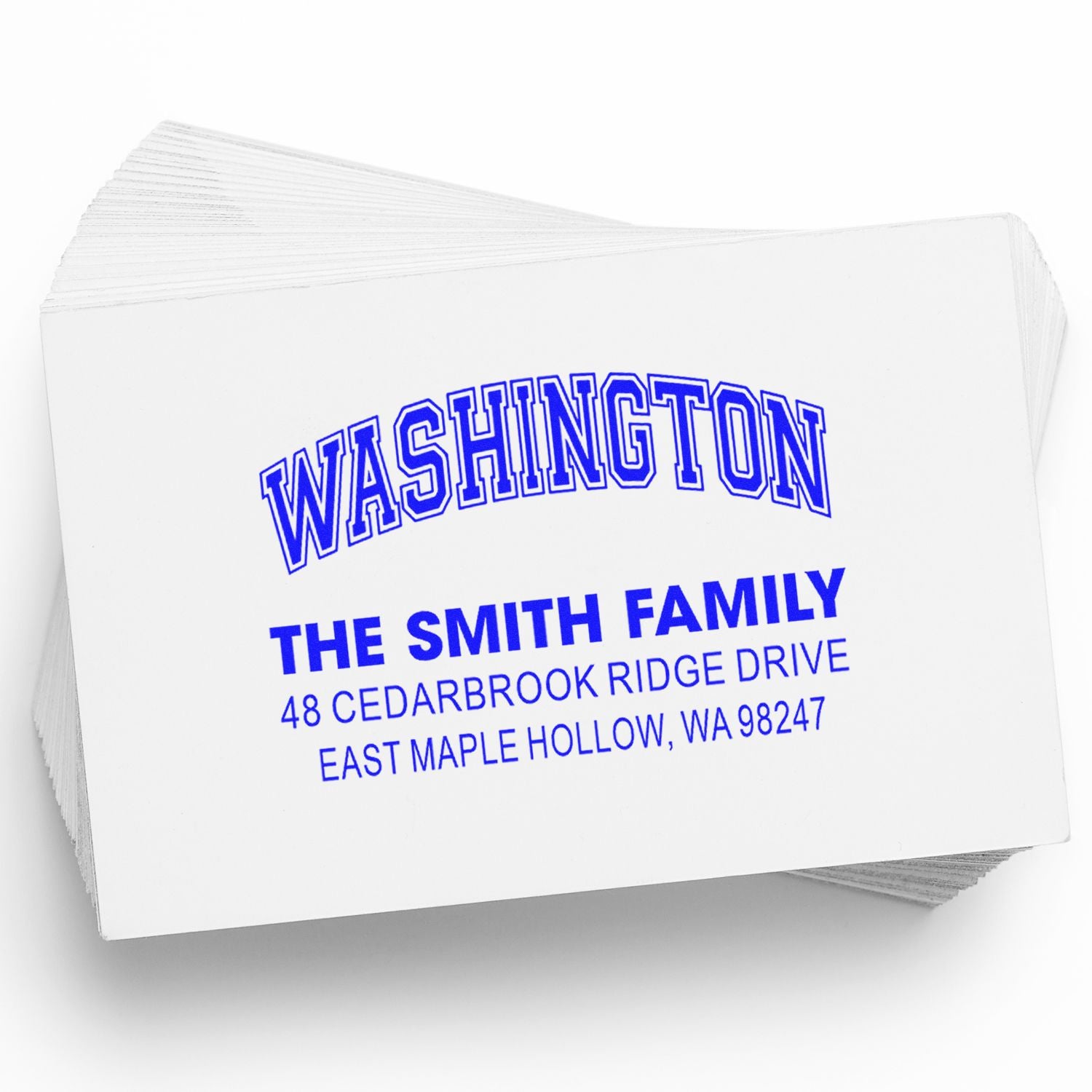 Stack of personalized address stamps with blue Washington text for The Smith Family, 48 Cedarbrook Ridge Drive, East Maple Hollow, WA 98247.