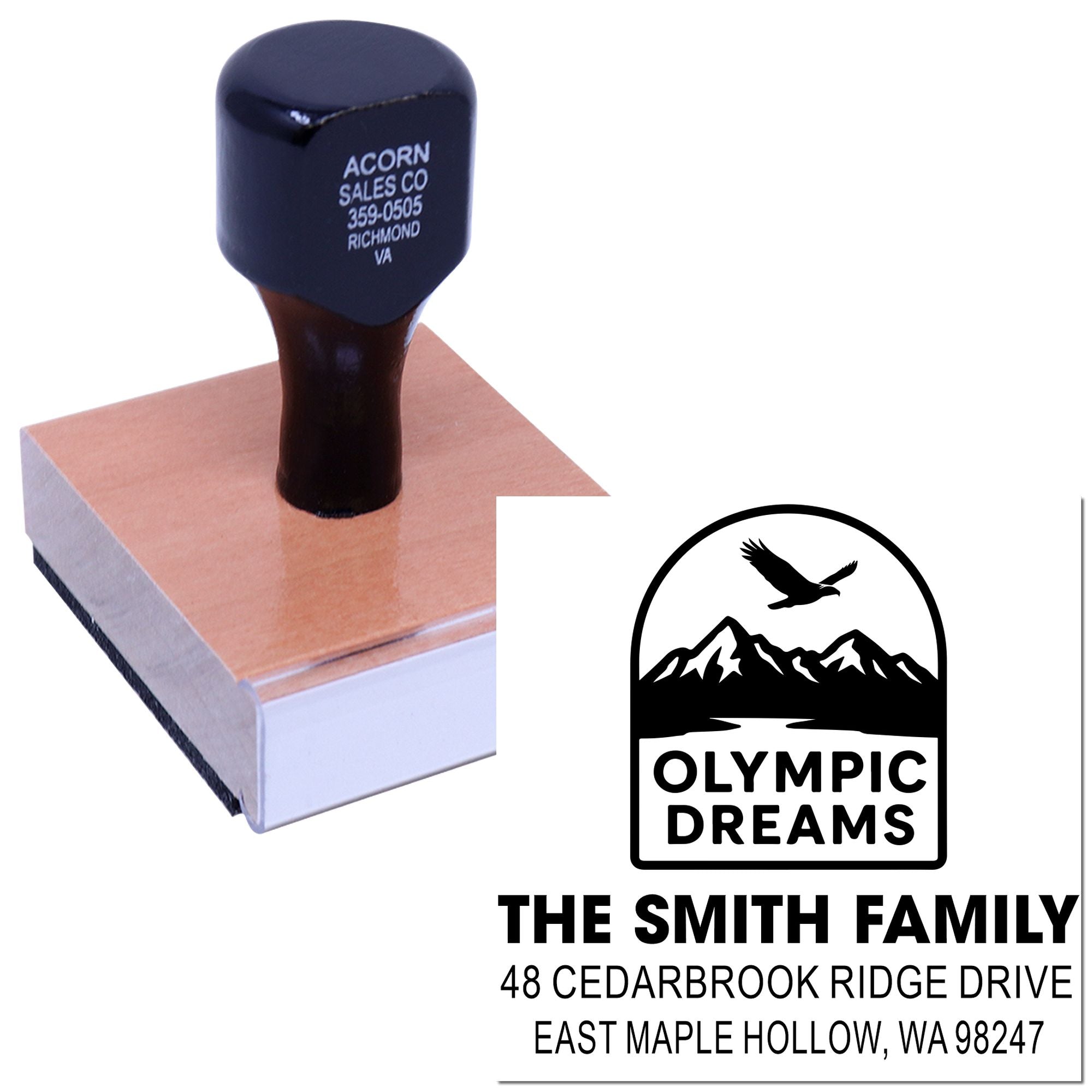 Custom rubber stamp with wooden handle on ink pad, featuring Olympic Dreams family return address design with mountain and bird logo.