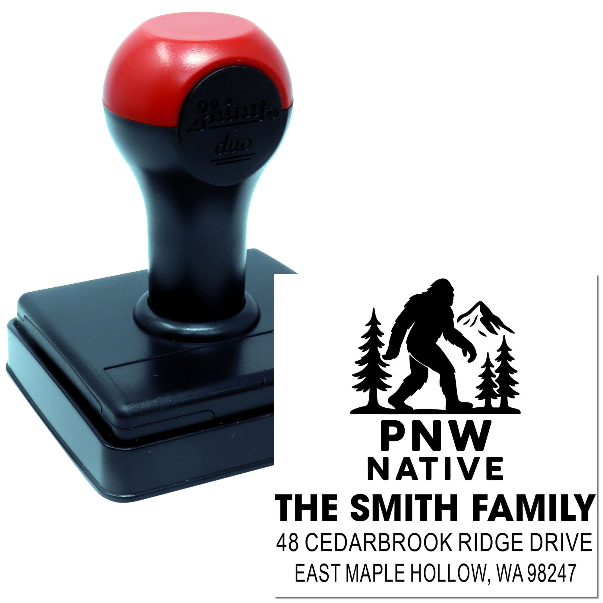 Custom self-inking address stamp with Bigfoot forest logo, shown on a black base with red handle and sample imprint reading PNW Native.