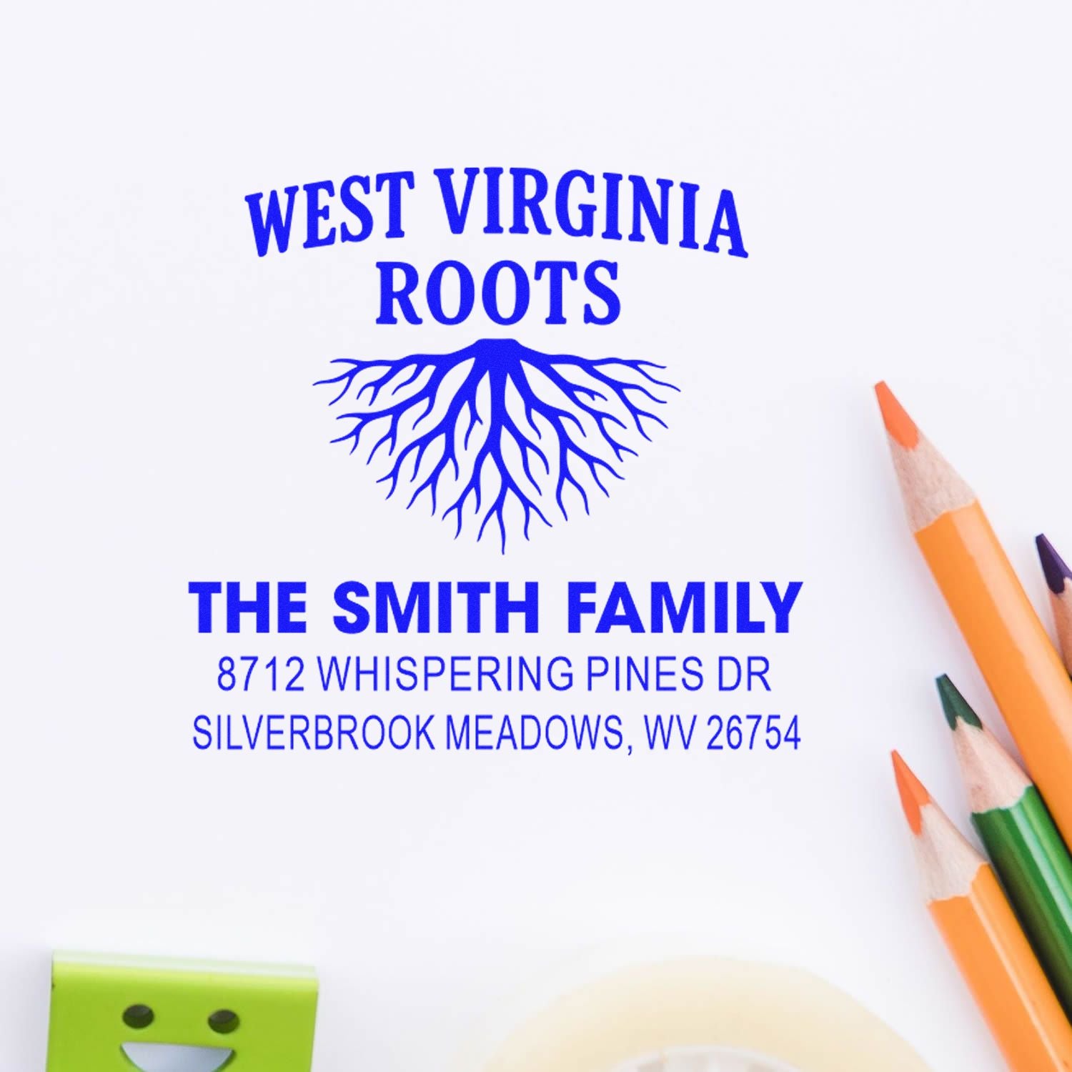 West Virginia Roots personalized address stamp with blue tree roots, The Smith Family name, and Silverbrook Meadows, WV address beside colored pencils.