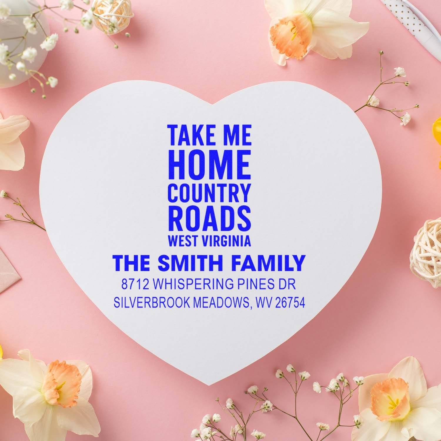 Custom heart-shaped return address stamp with Take Me Home Country Roads, West Virginia and The Smith Family on a pink floral background.