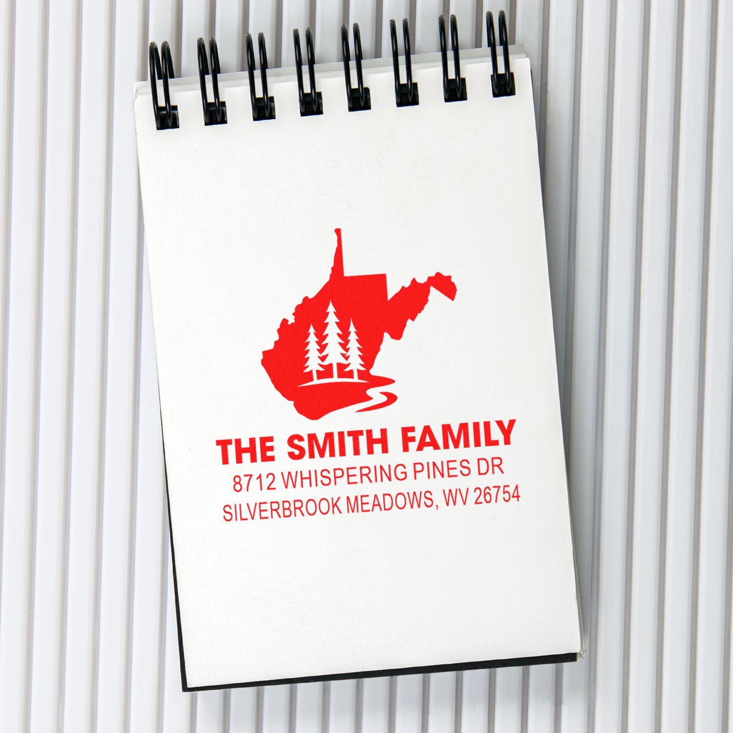 Personalized address stamp notebook with red West Virginia family logo, The Smith Family, and Silverbrook Meadows, WV address.