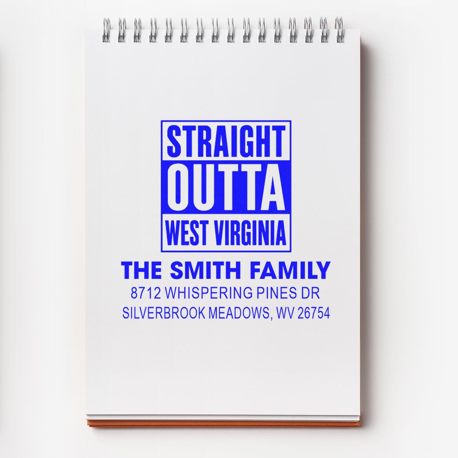 Custom address stamp on a spiral notepad, reading Straight Outta West Virginia for The Smith Family with Silverbrook Meadows address.