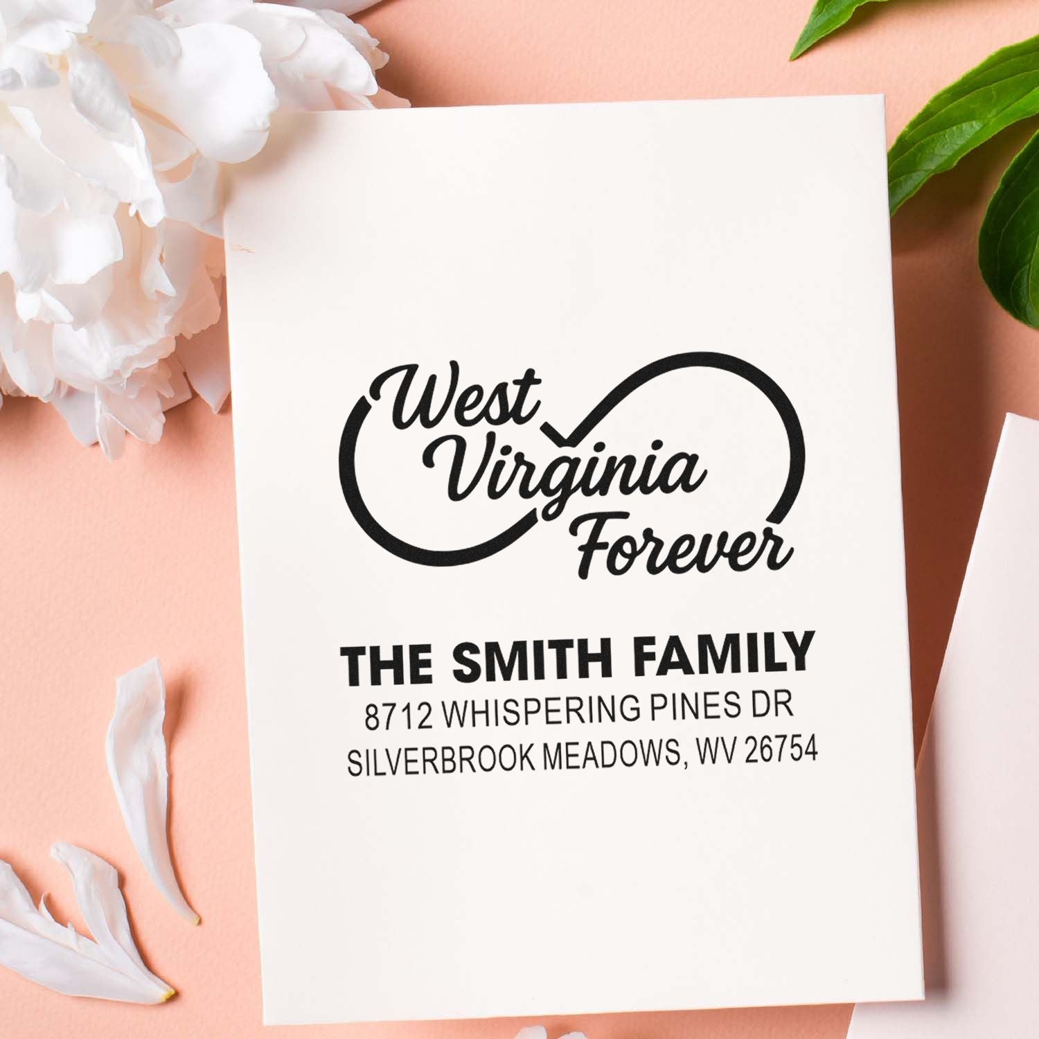 Personalized West Virginia Forever address stamp for The Smith Family on a white card, styled with flowers and green leaves on a pink background.