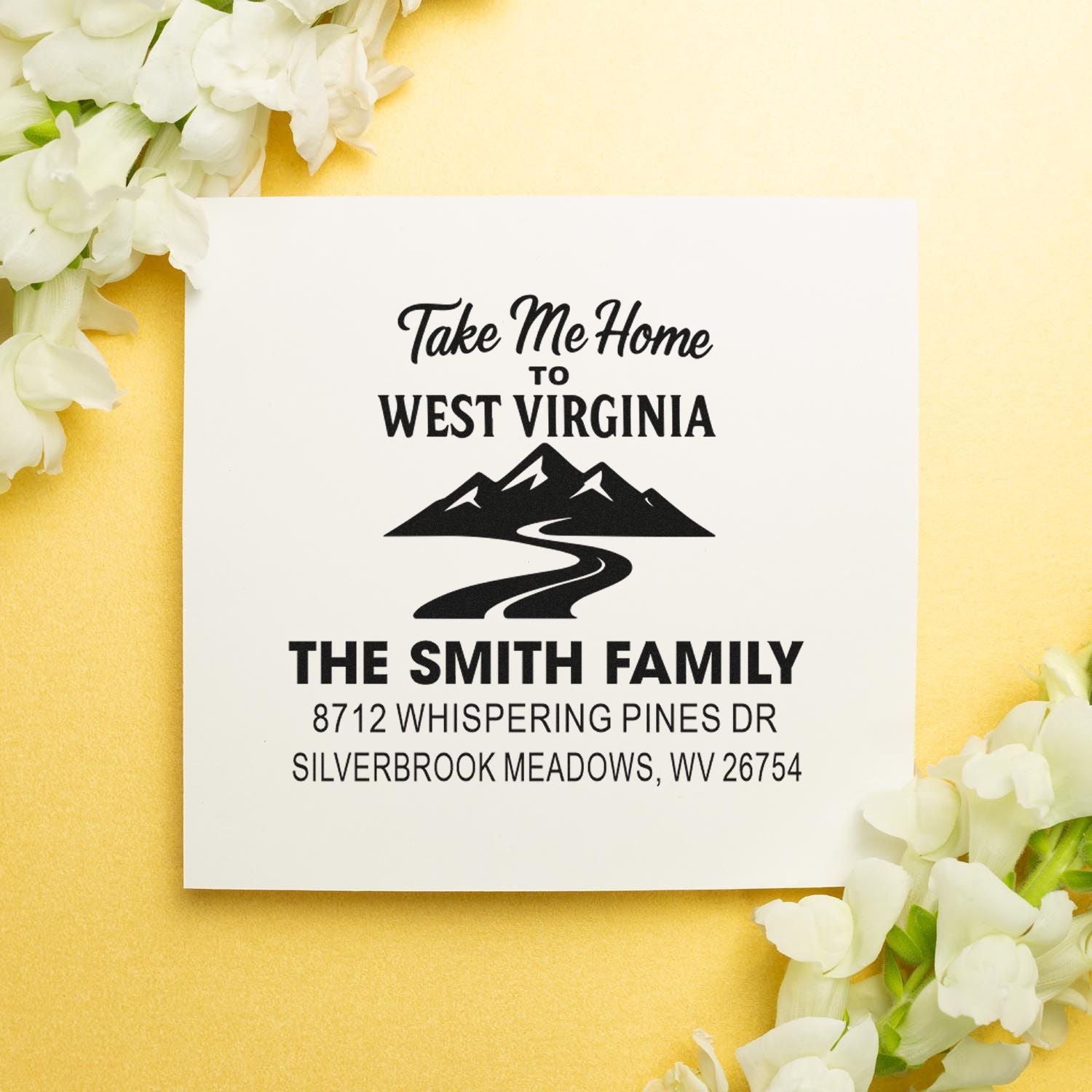 Personalized return address stamp reading Take Me Home to West Virginia with mountain road design, shown on a yellow floral background.