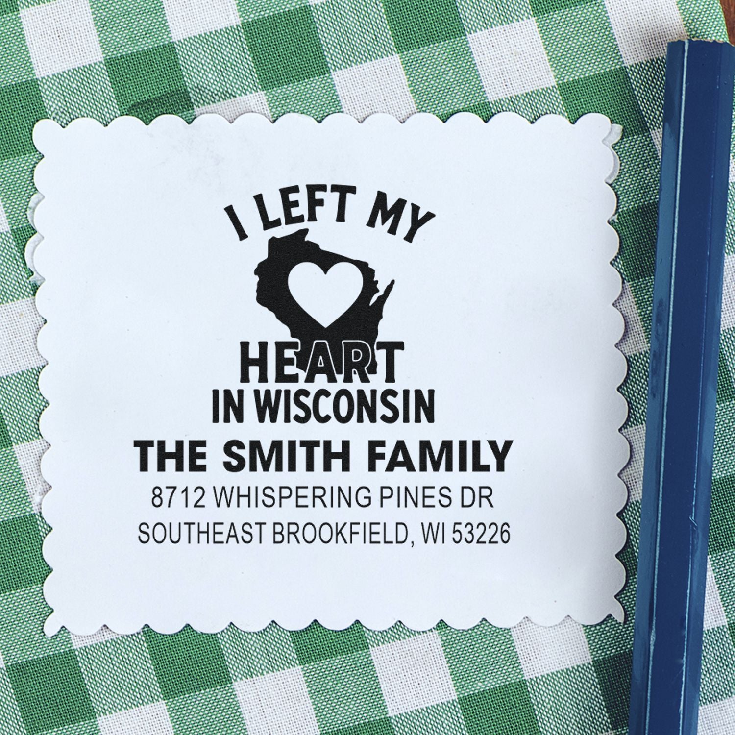 Custom I Left My Heart in Wisconsin address stamp for The Smith Family on green gingham cloth, with blue stamp handle.