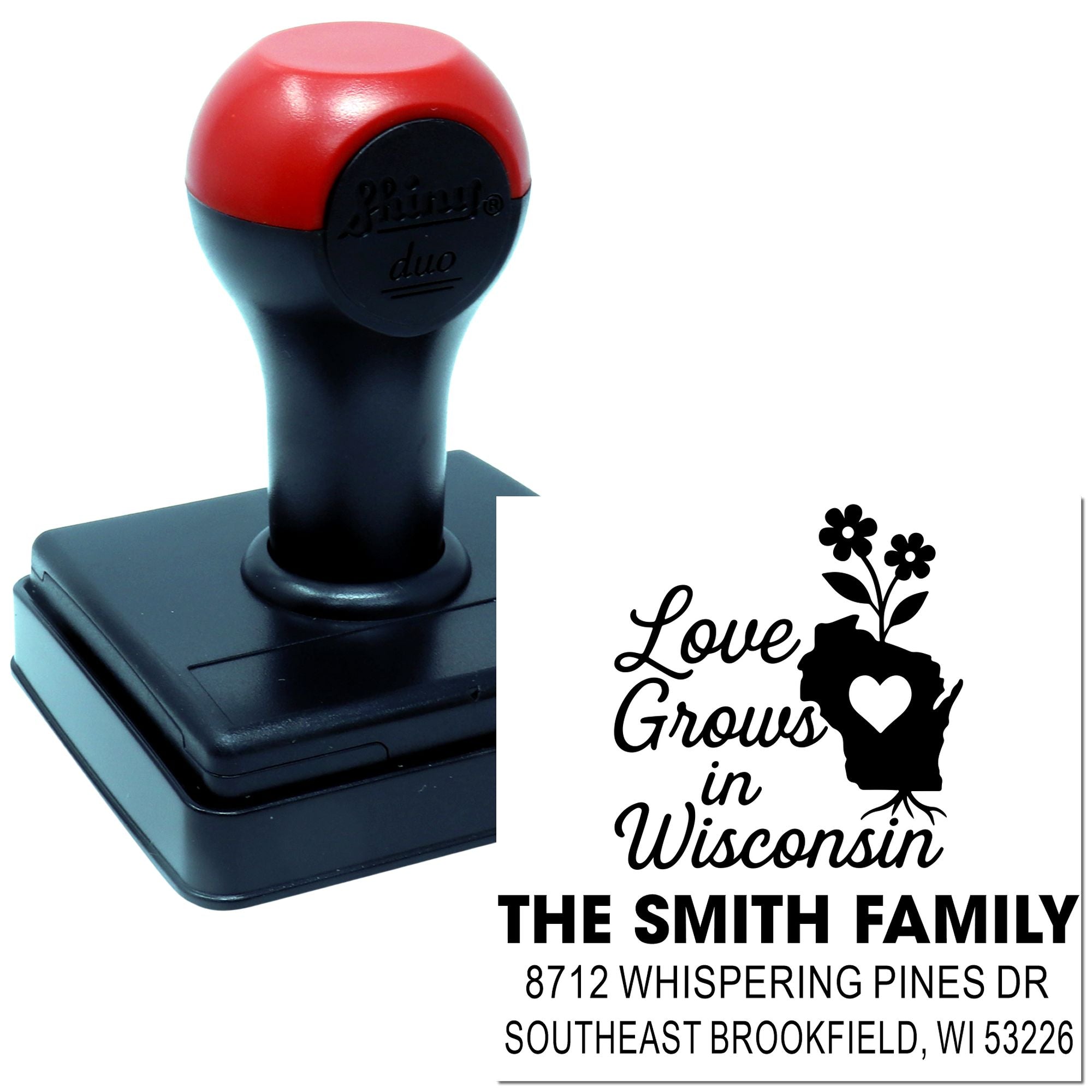 Custom self-inking stamp with red and black handle on white background, imprinting Love Grows in Wisconsin with family name and address.