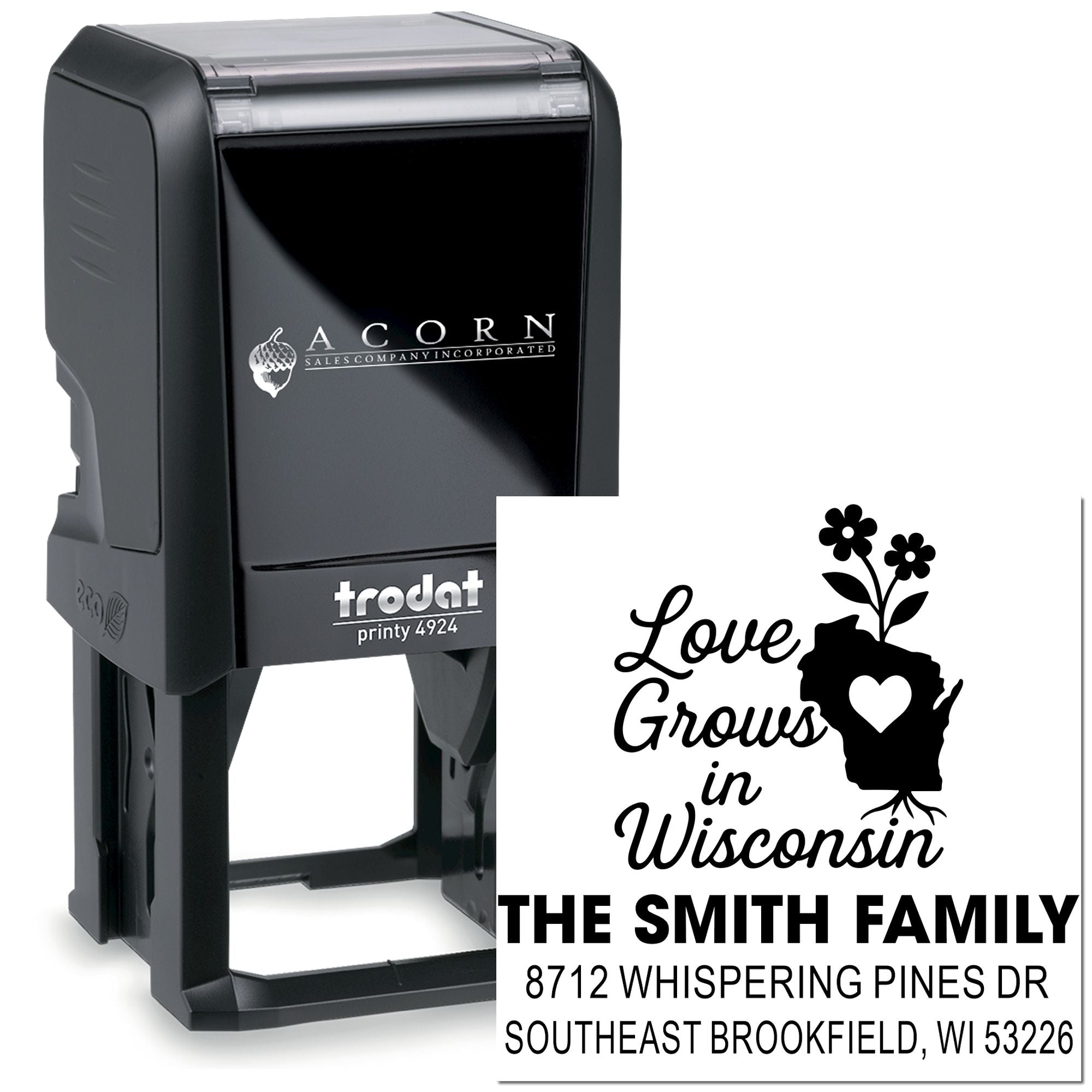 Custom Trodat self-inking stamp with Love Grows in Wisconsin design, family name, and address imprint shown on a white background.