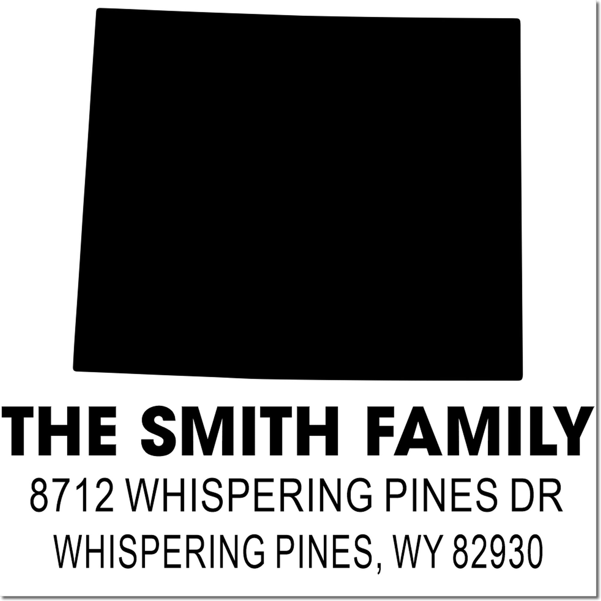 Custom family address stamp with black logo block, "The Smith Family," and return address for Whispering Pines, WY 82930.