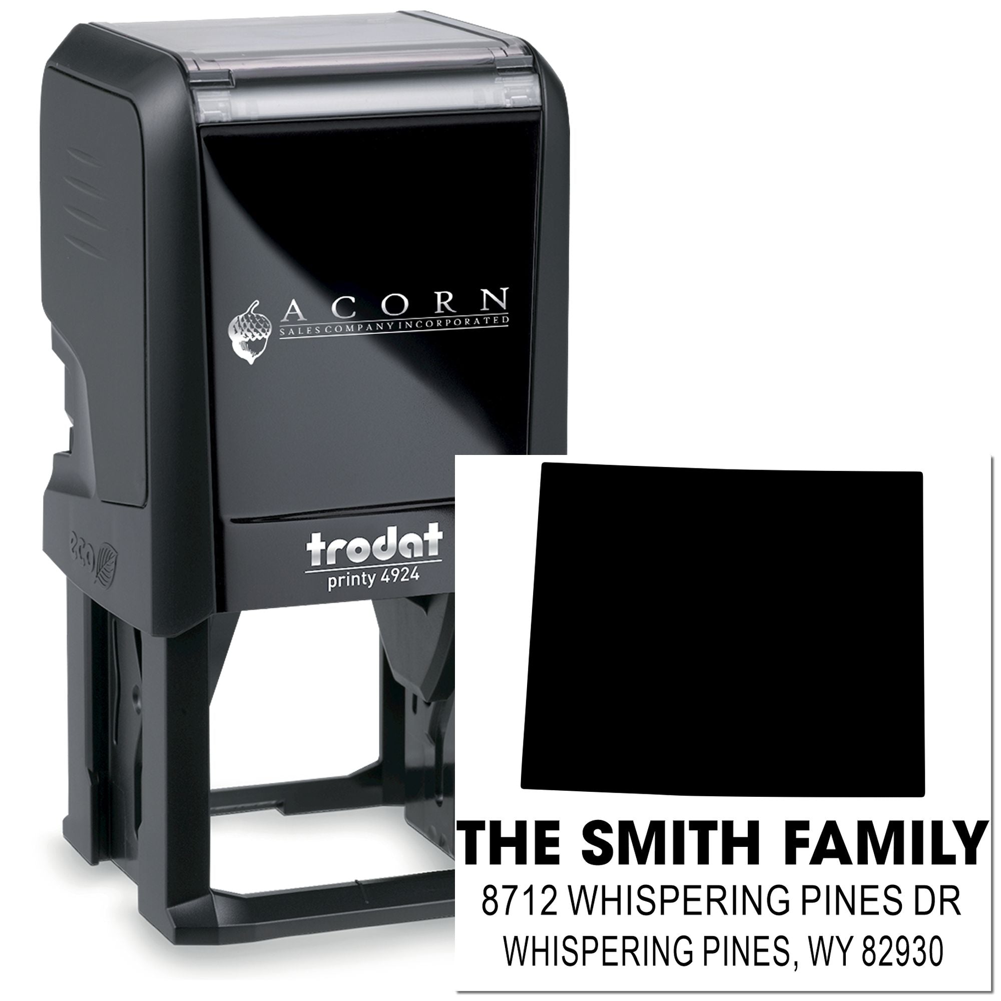 Custom self-inking Trodat address stamp with black ink, showing The Smith Family and Whispering Pines, WY 82930 on a white background.