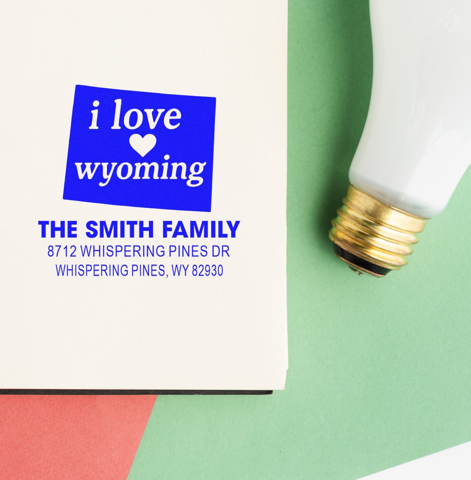 Custom self-inking stamp for The Smith Family, featuring an I love Wyoming address imprint on white paper with a green background and stamp tool.