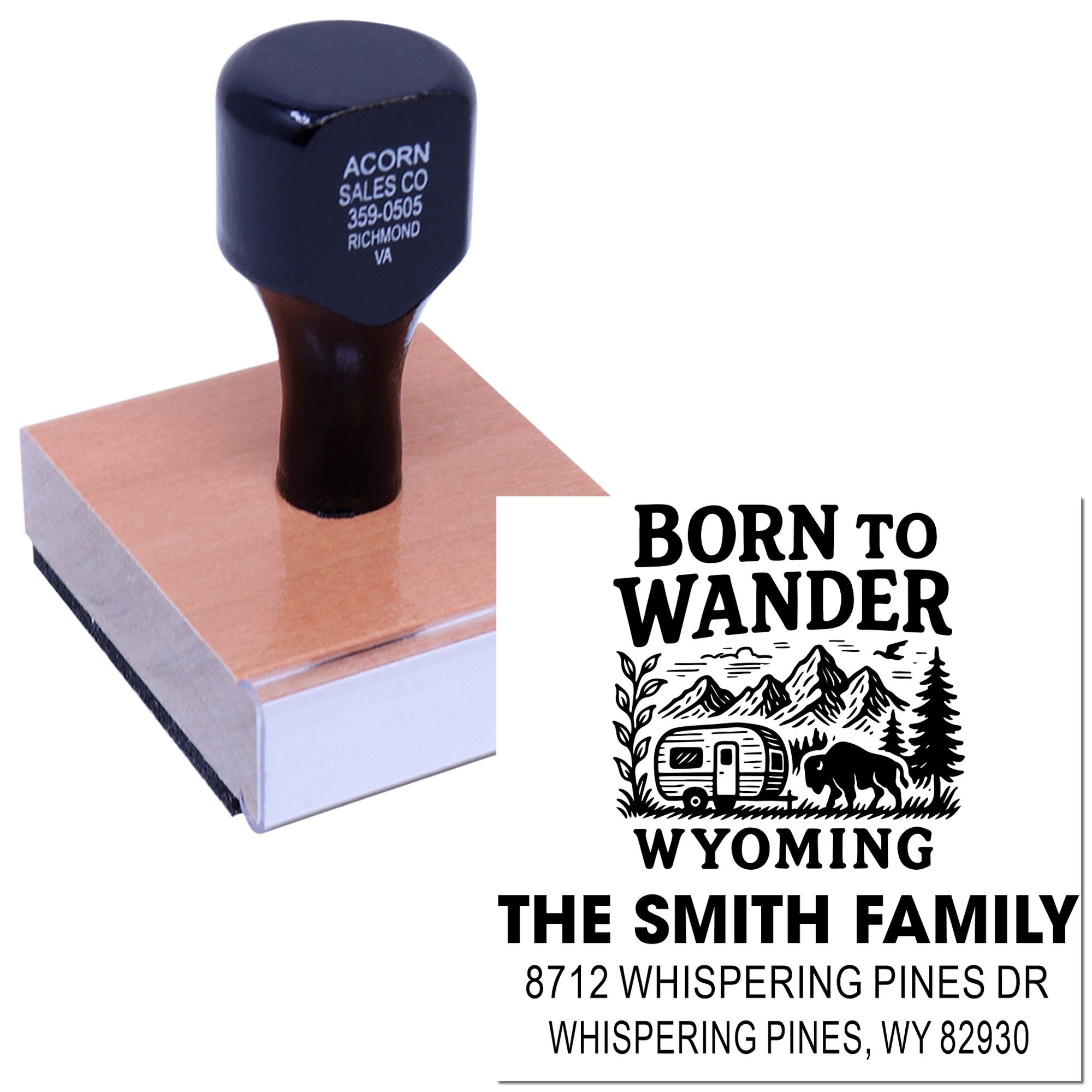 Custom rubber stamp on wooden base with Born to Wander Wyoming design, featuring mountains, camper, bison, and family address.