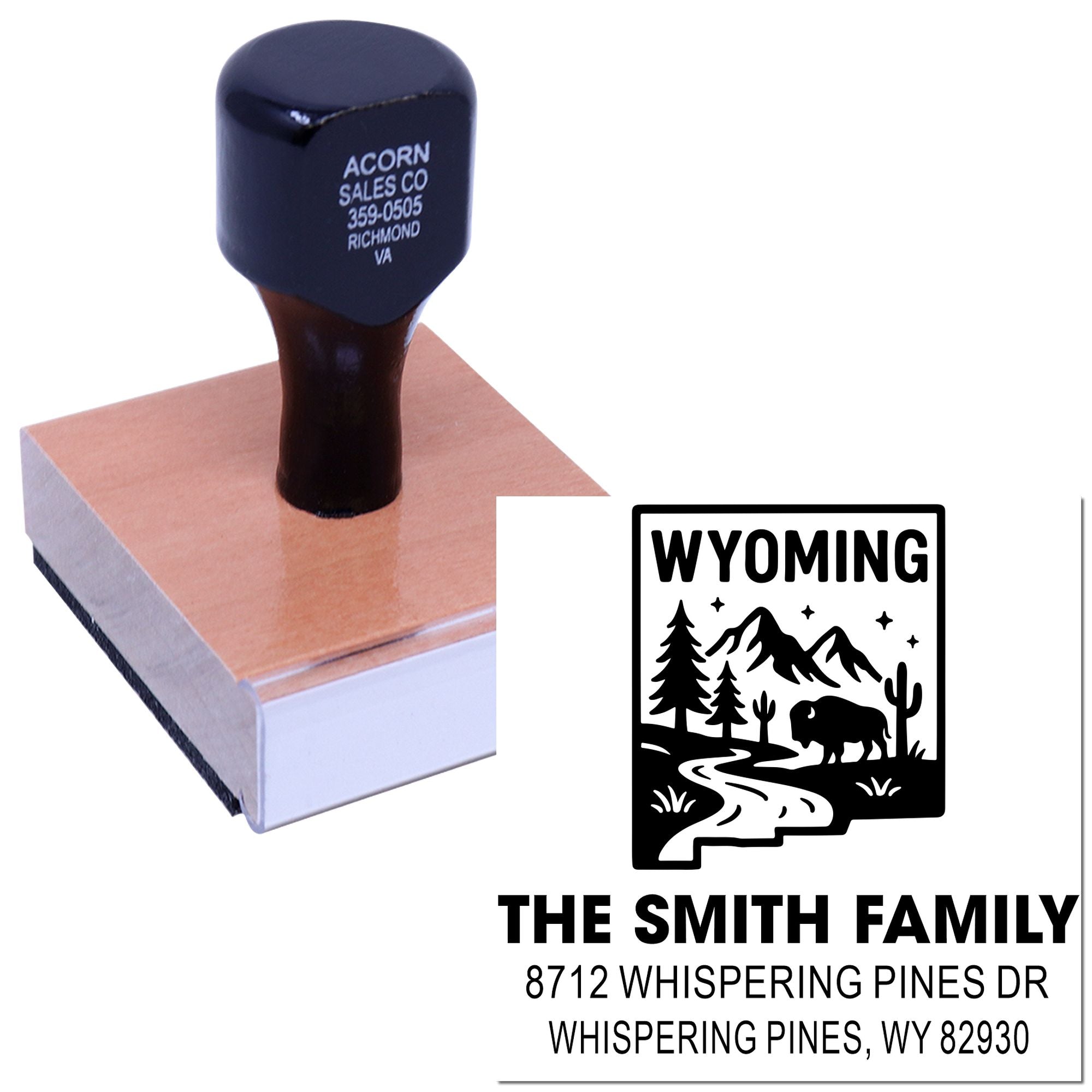 Personalized Wyoming address rubber stamp with mountain, pine and bison design, mounted on a wooden handle, shown on a white background.