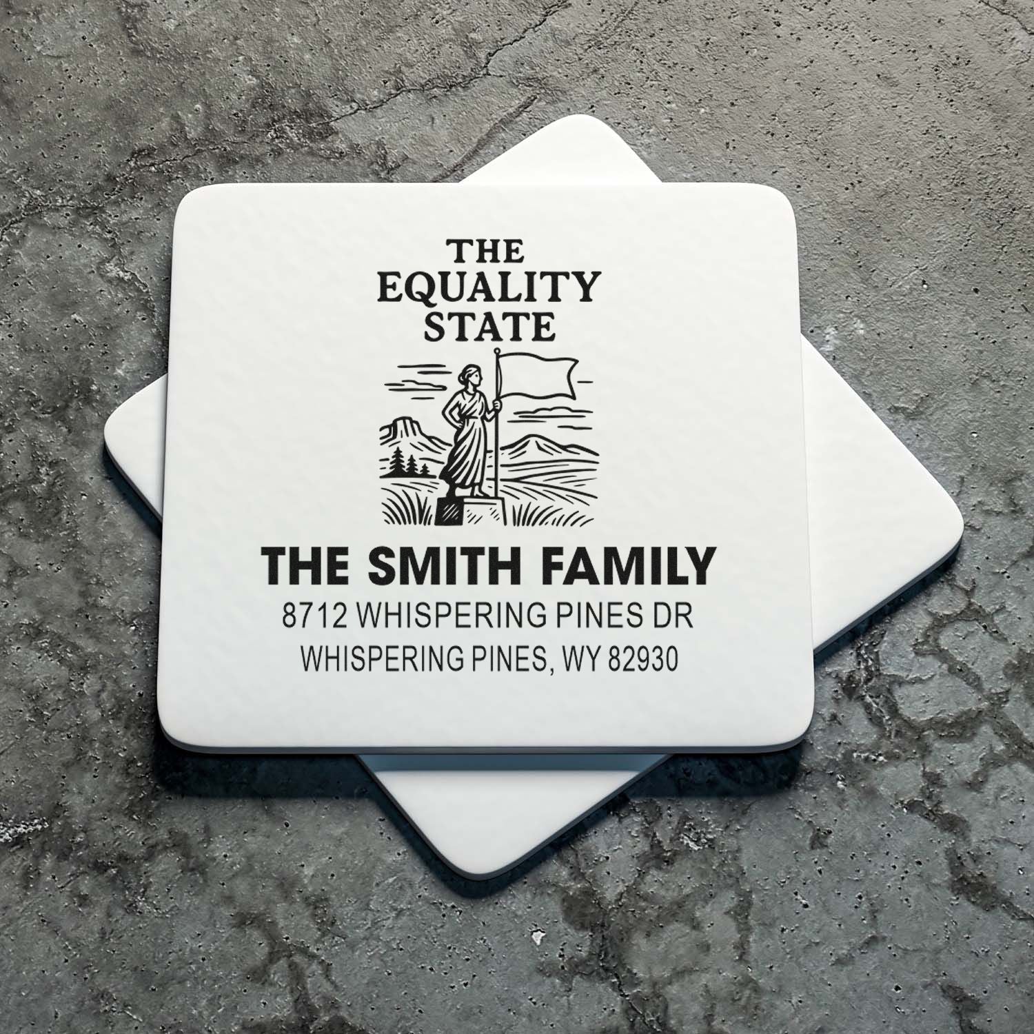 Personalized self-inking address stamps for The Smith Family, featuring The Equality State design, on a gray textured surface.